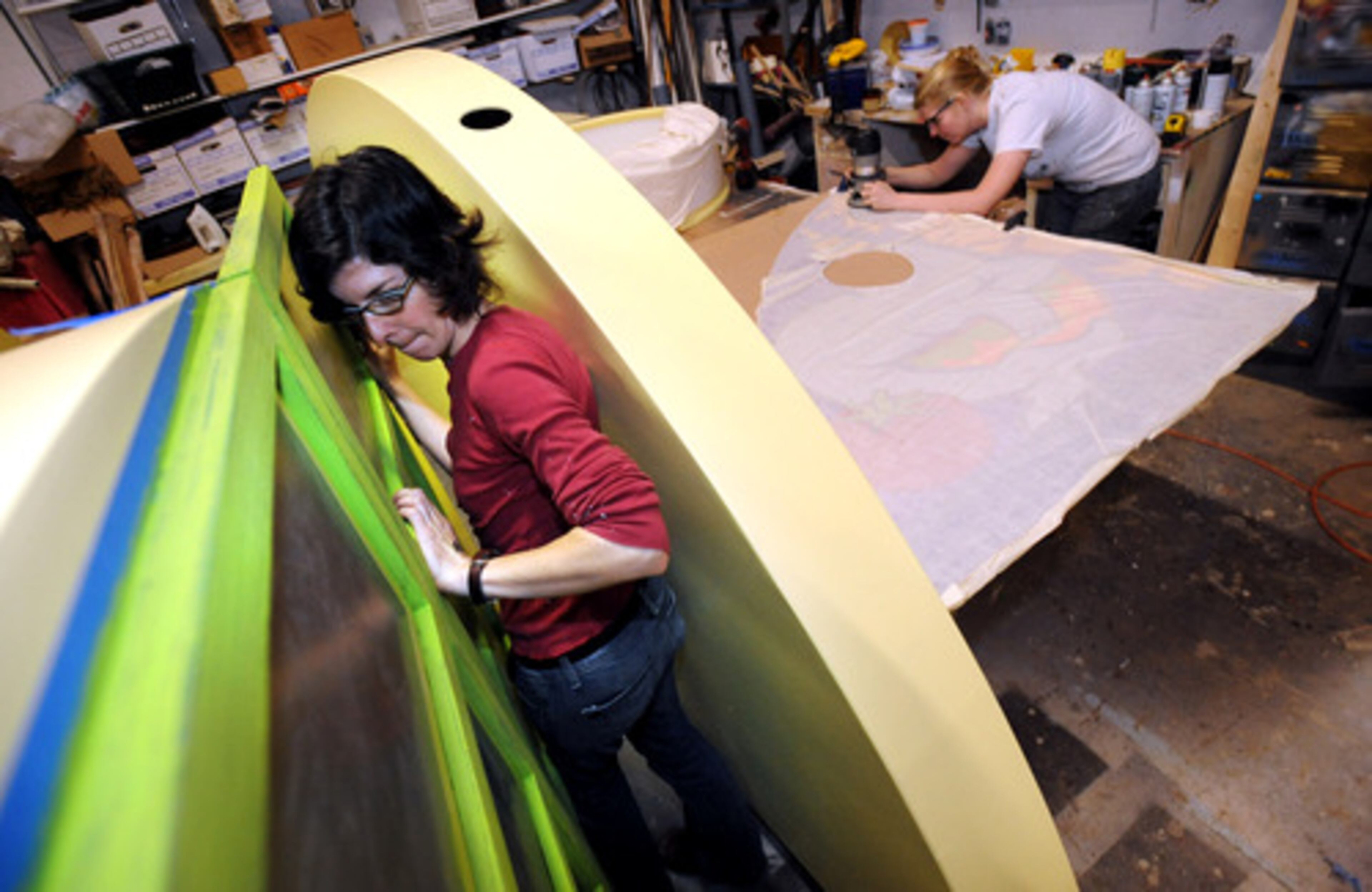 Imagine It! Children's Museum of Atlanta has mostly borrowed exhibits, but this time, it's designing and making its own. Exhibits Development Manager Roxanne Flagg (left) and Technical Director Megan Kier work on one of components Wednesday.