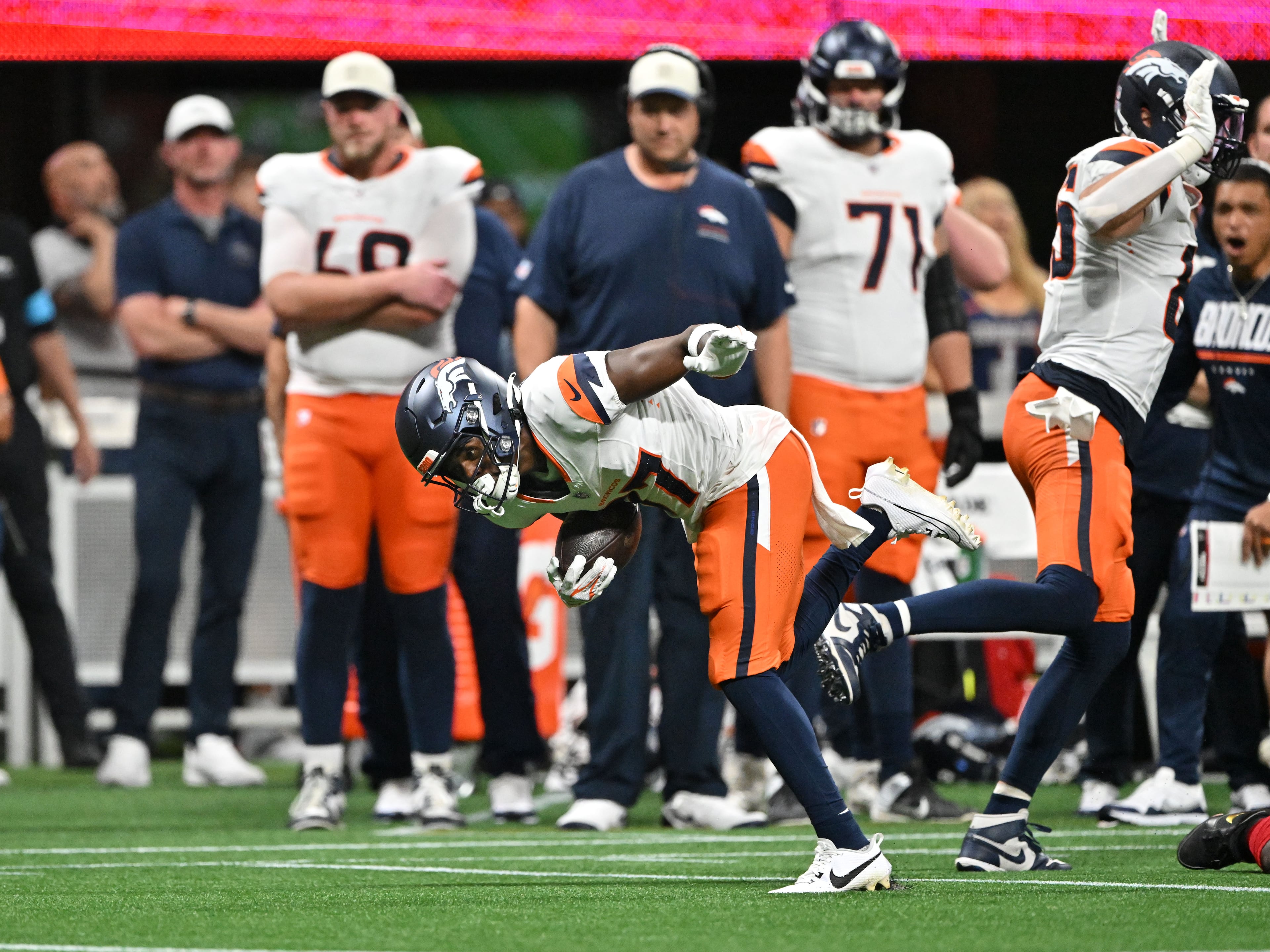 Broncos wide receiver Cameron Ross eludes a tackle from the Falcons during the first half of their preseason game at Mercedes-Benz Stadium on Friday, Aug. 14, 2026, in Atlanta. (Hyosub Shin/AJC)