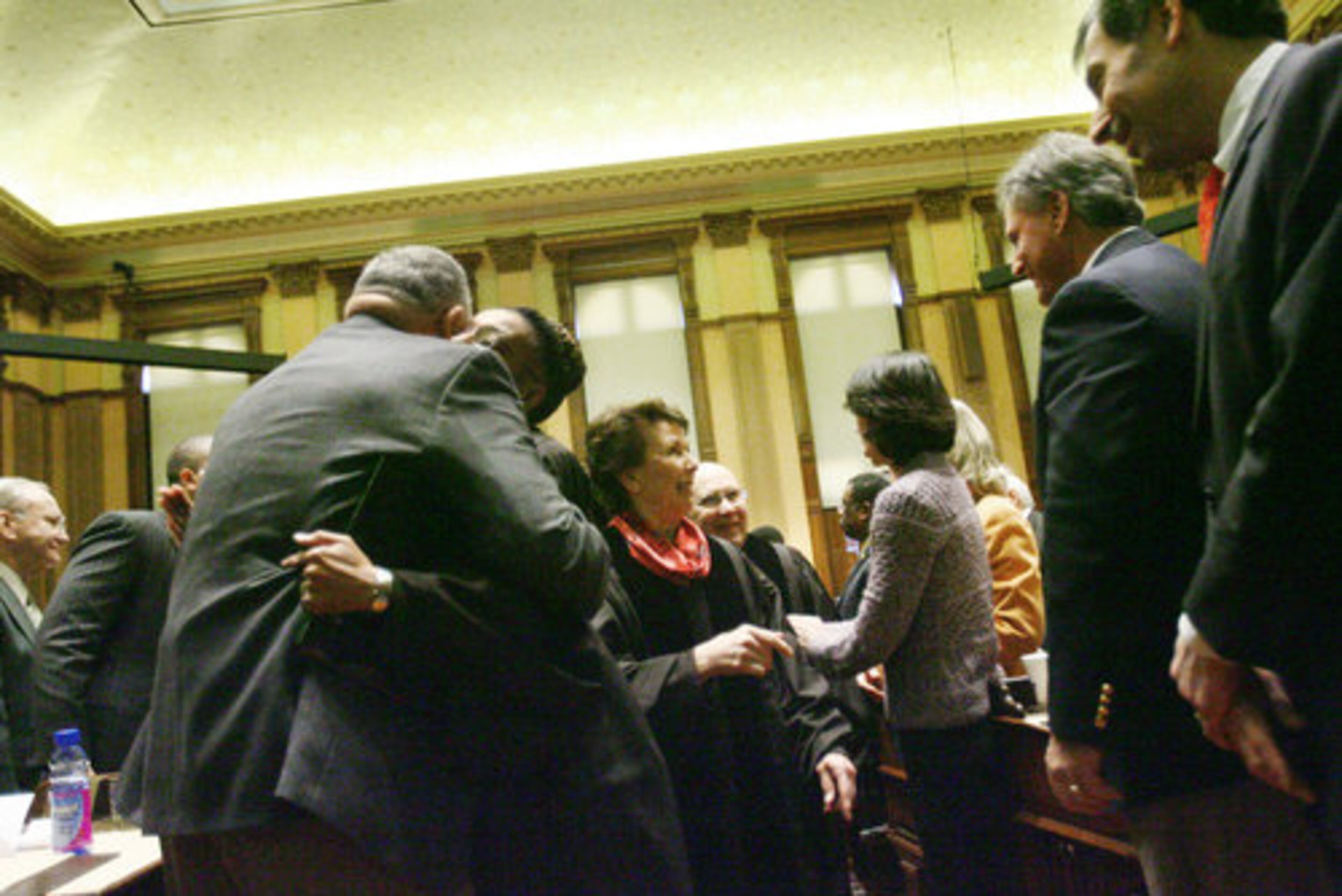 Rep. Lynmore James (left) D-Montezuma, hugs Chief Justice Leah Ward Sears. Presiding Justice Carol W. Hunstein (center) will become Chief Justice upon Ward Sears' retirement.