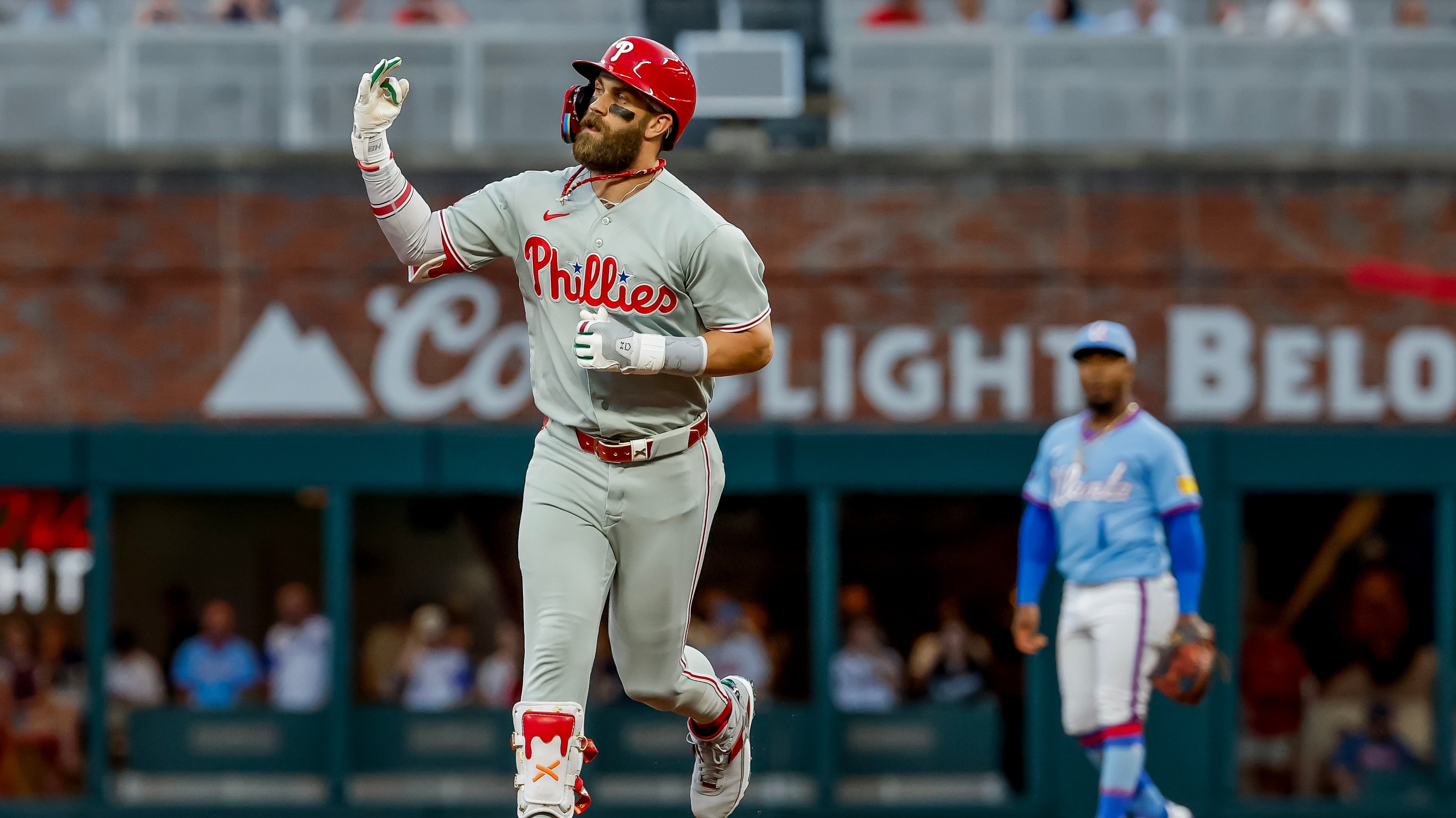 Philadelphia Phillies' Bryce Harper, foreground, reacts while rounding the bases after hitting a solo home run against the Atlanta Braves during the first inning of a baseball game, Saturday, Sept. 12, 2026, in Atlanta. (Erik S. Lesser/AP)