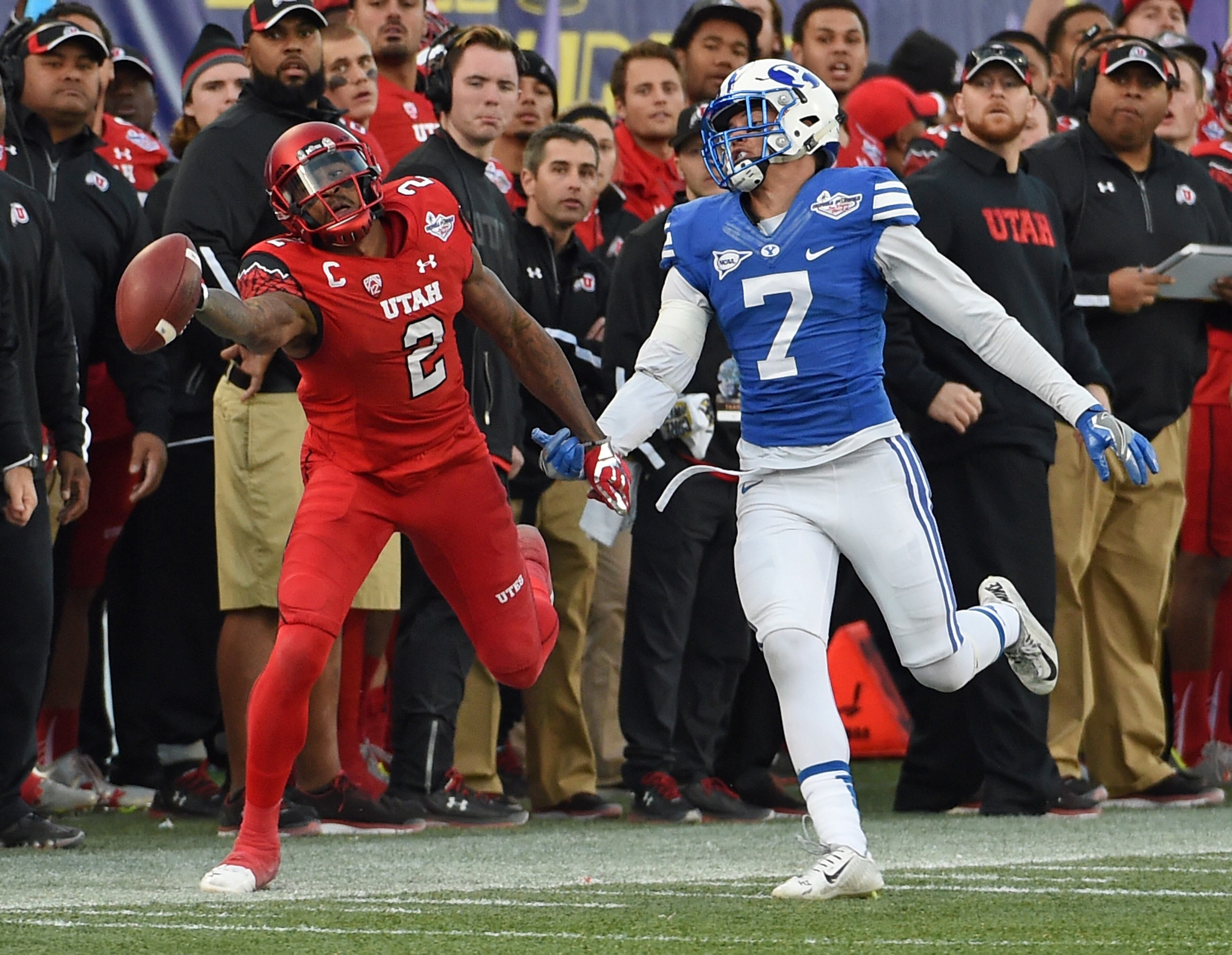 LAS VEGAS, NV - DECEMBER 19: Defensive back Micah Hannemann #7 of the Brigham Young Cougars is called for pass interference as he defends wide receiver Kenneth Scott #2 of the Utah Utes during the Royal Purple Las Vegas Bowl at Sam Boyd Stadium on December 19, 2015 in Las Vegas, Nevada. Utah won 35-28. (Photo by Ethan Miller/Getty Images)