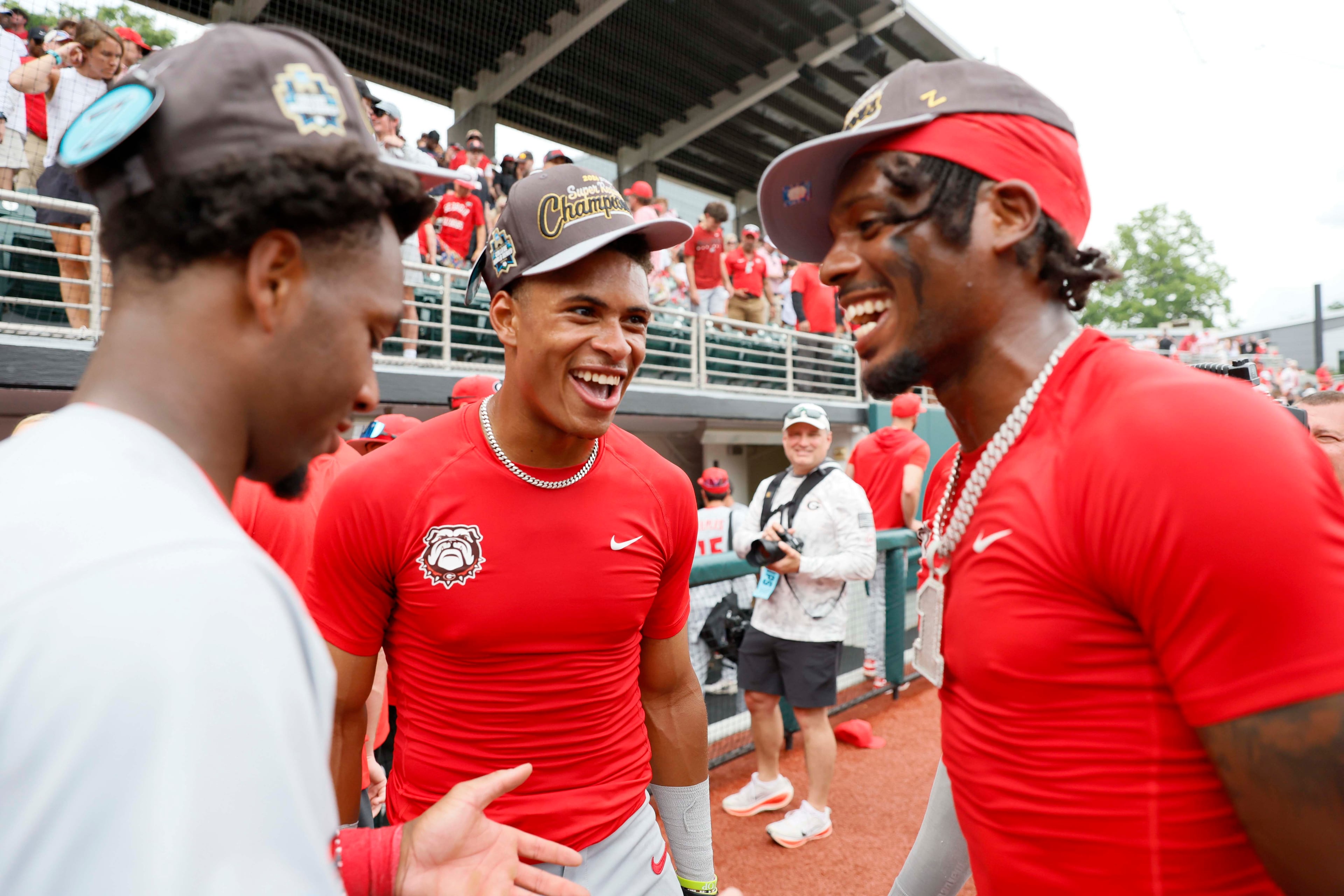 Georgia Bulldogs infielder Ryan Black (2), in the center, celebrates with teammates Tre Phelps (1) and Ryan Wynn (0) after winning the NCAA Super Regional at Foley Field on Sunday, June 7, 2026, in Athens. Miguel Martinez/AJC)