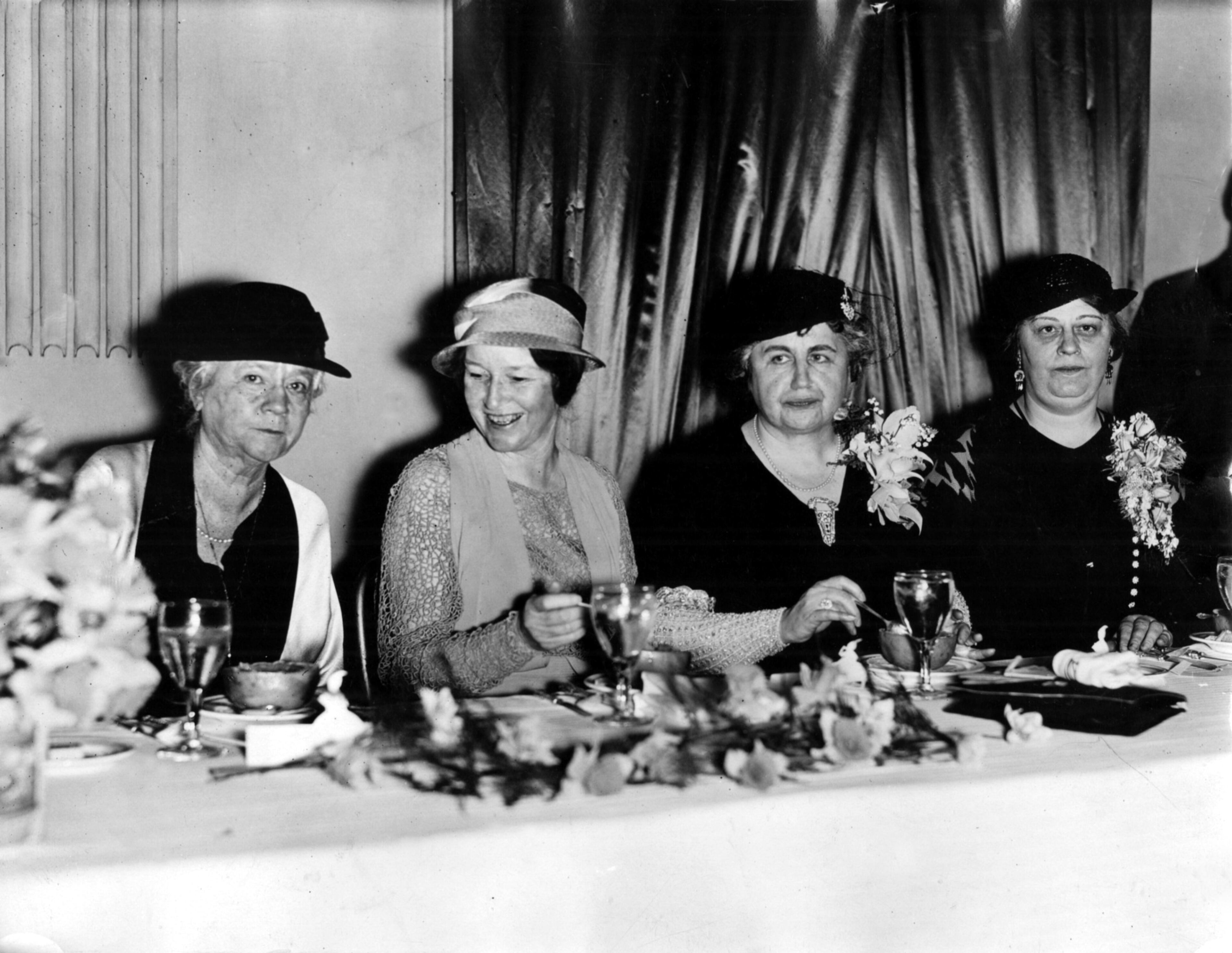 Original caption: "Left to right: Miss Martha Berry, founder and president of the Berry Schools at Mt. Berry, Ga., Mrs. Mattie Talmadge, wife of Georgia Governor Eugene Talmadge, Mrs. Edith Wilson, widow of former president Woodrow Wilson, and Mrs. Edgar Alexander, national Democratic committeewoman for Georgia, shown at the luncheon given in honor of Mrs. Wilson by the Woman's Democratic Club of Fulton County, at the Capitol City Club, March 20, 1933. (Staff photo by Winn)"