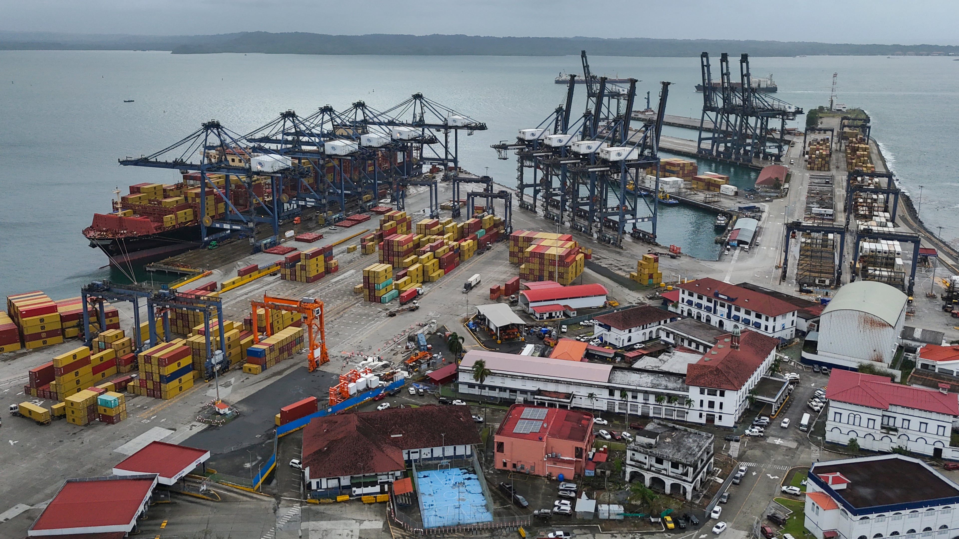 FILE - Cranes load and unload containers from cargo ships at the Cristobal port, operated by the Panama Ports Company, in Colon, Panama, Feb. 6, 2026. (AP Photo/Matias Delacroix, File)