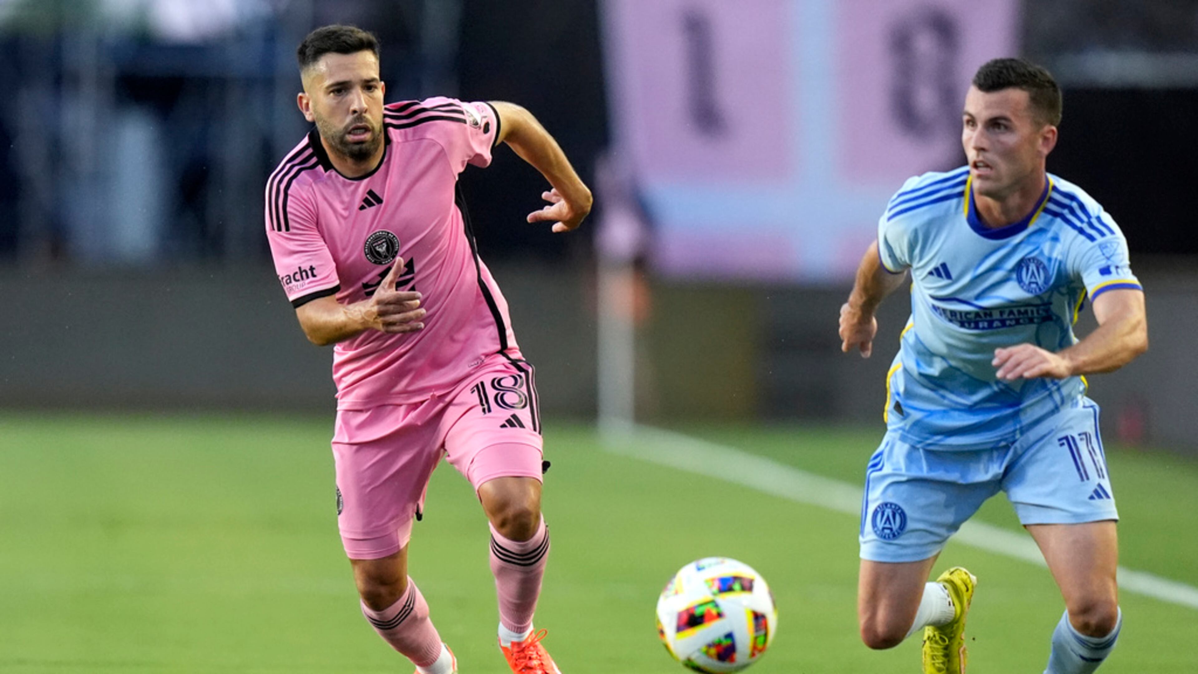 Inter Miami defender Jordi Alba (18) and Atlanta United defender Brooks Lennon (11) chase the ball during the first half of an MLS soccer match Wednesday, May 29, 2024, in Fort Lauderdale, Fla. (AP Photo/Lynne Sladky)