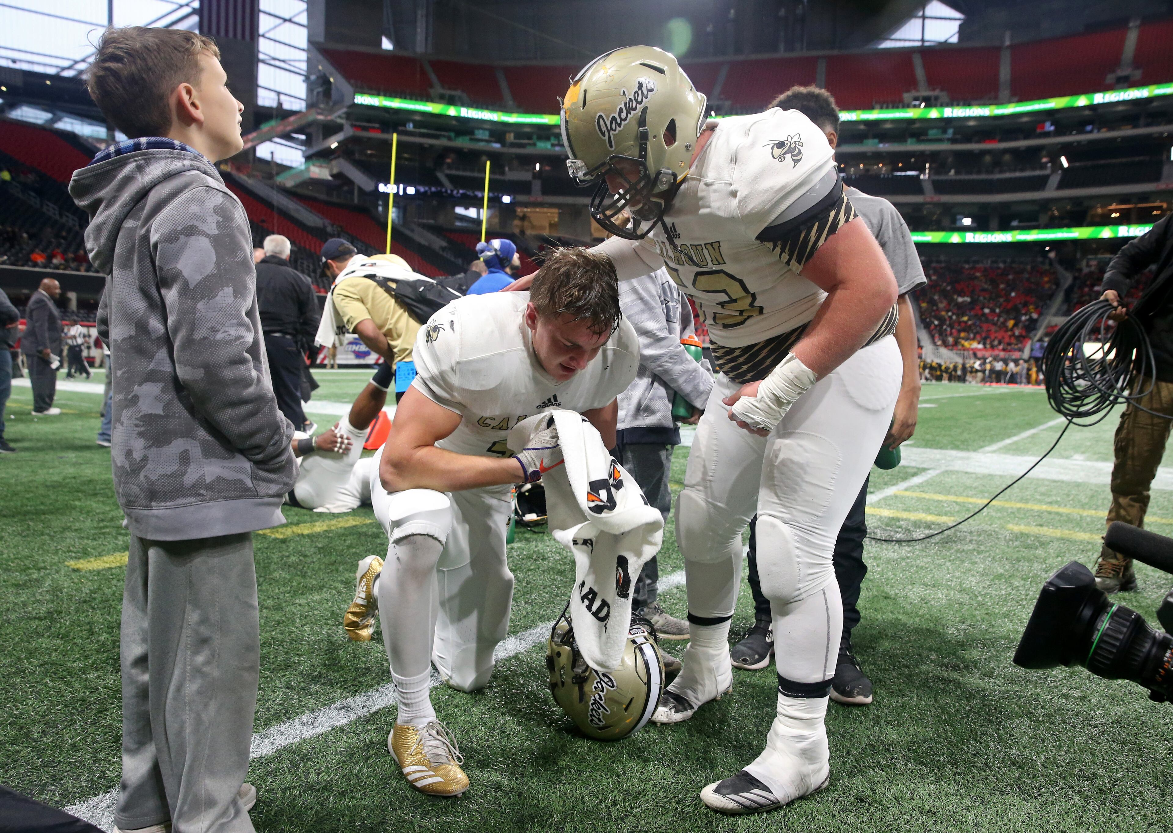 Calhoun lineman J.C. Fuller (53) congratulates defensive back Brannon Spector (3) after he returned an interception for a touchdown in the first half of their game against Peach County during the Class AAA Championship at Mercedes-Benz Stadium Friday, December 8, 2017, in Atlanta. PHOTO / JASON GETZ