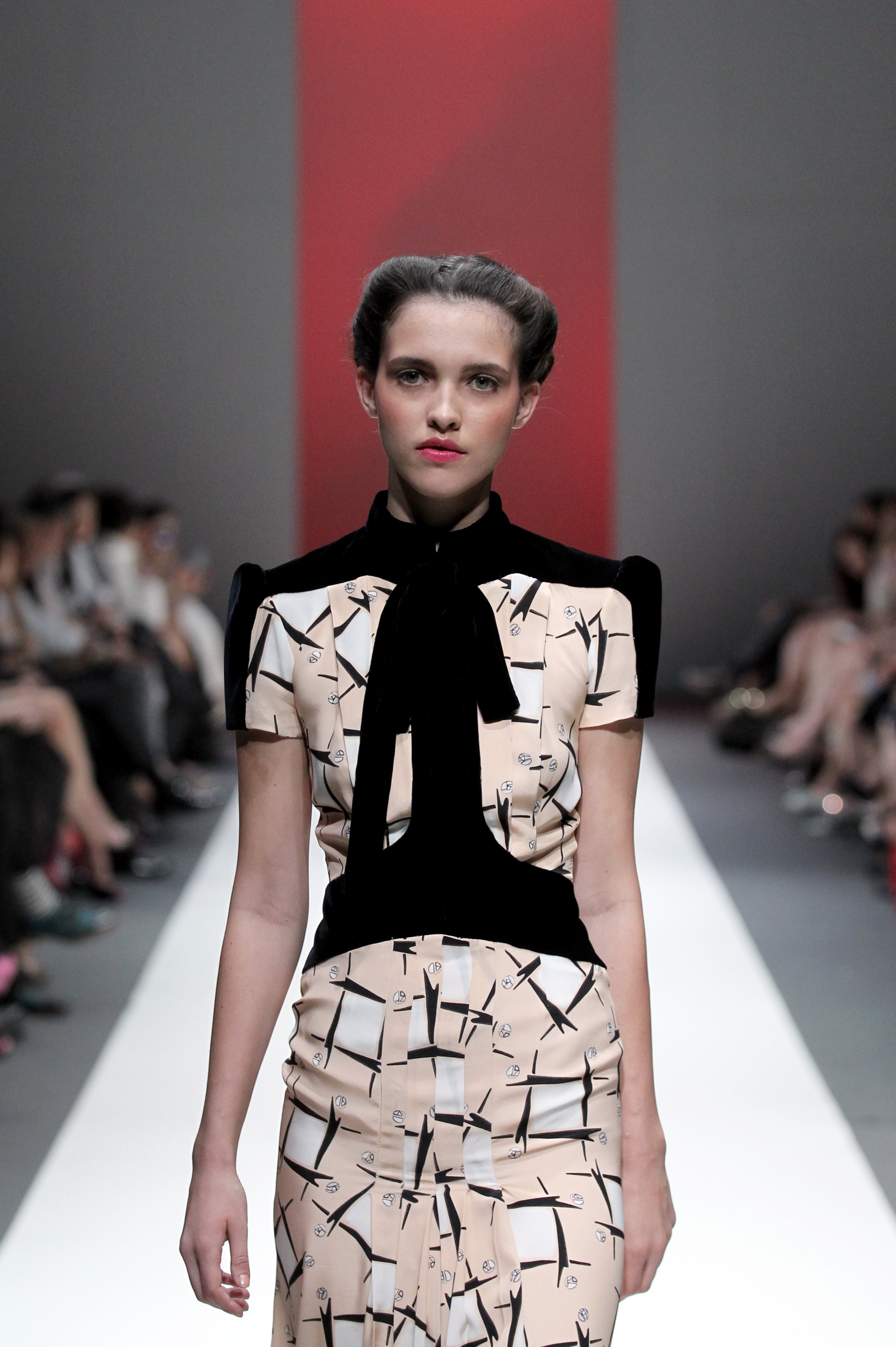 A model showcases an outfit by New York based designer Carolina Herrera for 'The House of Herrera' Fall 2013 collection, in Singapore, Wednesday, May 15, 2013, during the annual Fashion Festival held in the city-state. (AP Photo/Wong Maye-E)