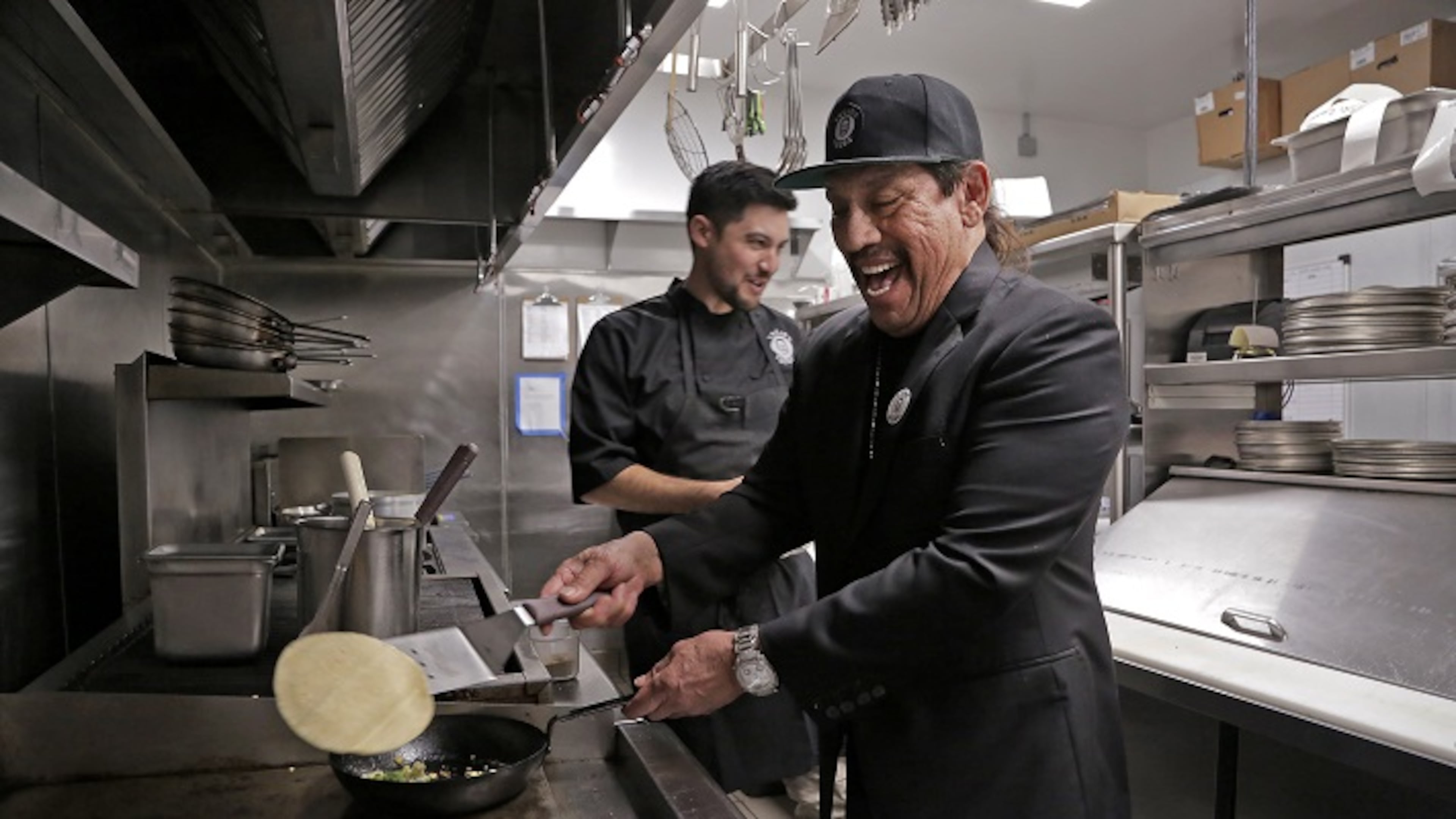 Actor Danny Trejo, right, and chef John-Carlos Kuramoto cook up their vegan cauliflower taco on Dec. 16, 2016 at Trejo's Cantina in Hollywood, Calif. (Myung J. Chun/Los Angeles Times/TNS)
