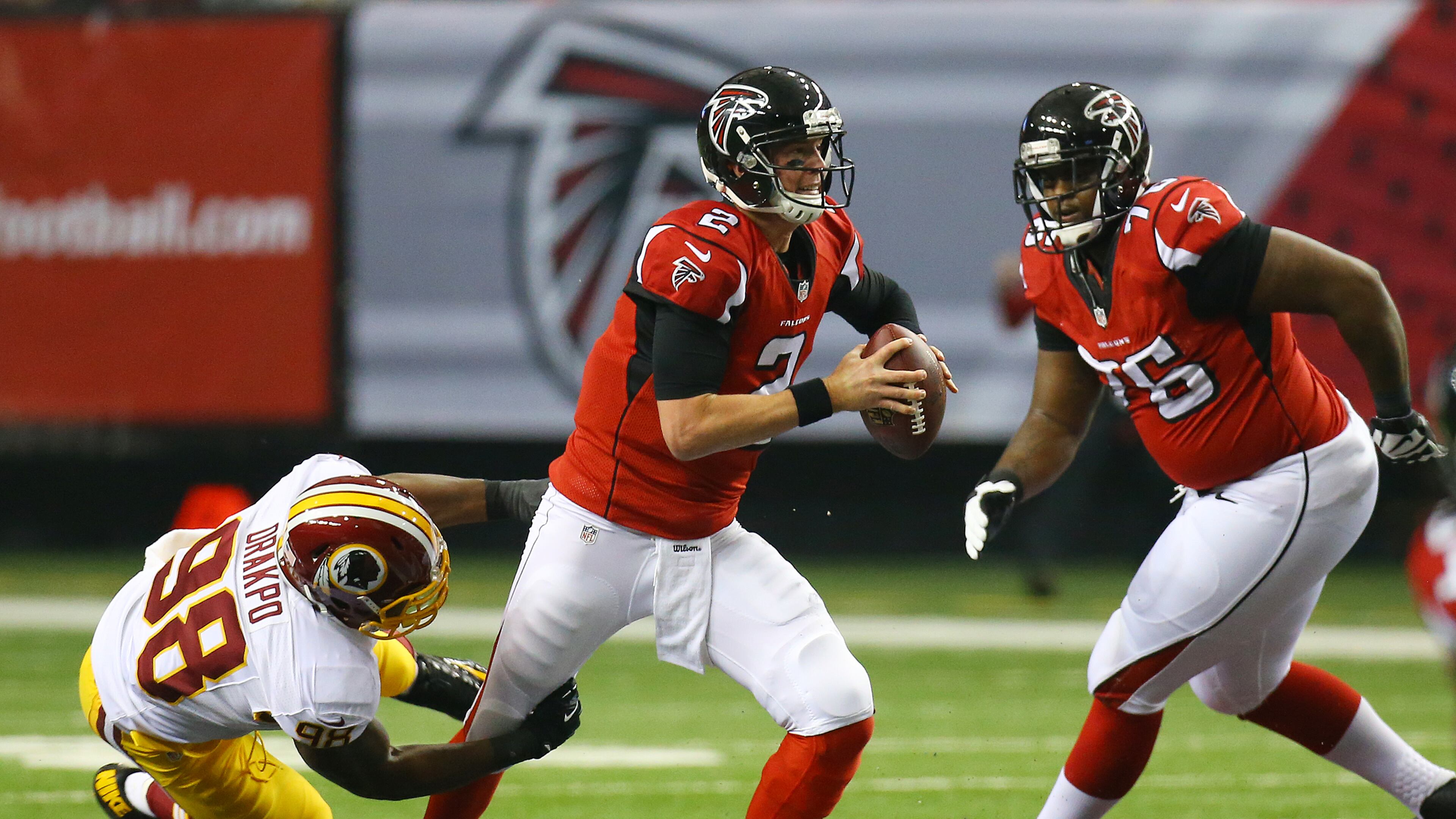 Falcons quarterback Matt Ryan avoids a sack breaking away from Redskins linebacker Brian Orakpo buying time to get off a pass during 1st half action in a NFL football game on Sunday, Dec. 15, 2013, in Atlanta.