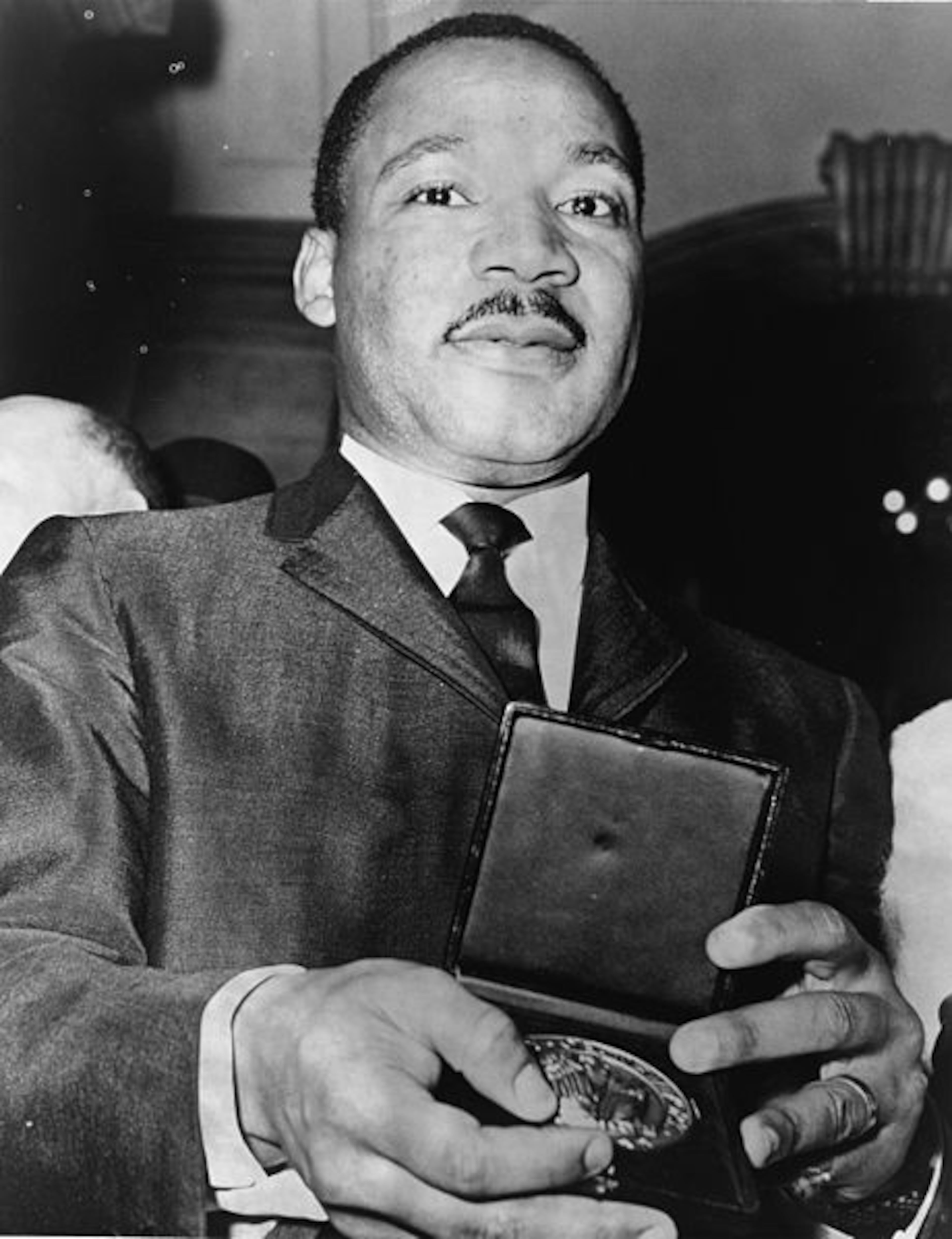 Martin Luther King, Jr. showing his medallion received from Mayor Wagner