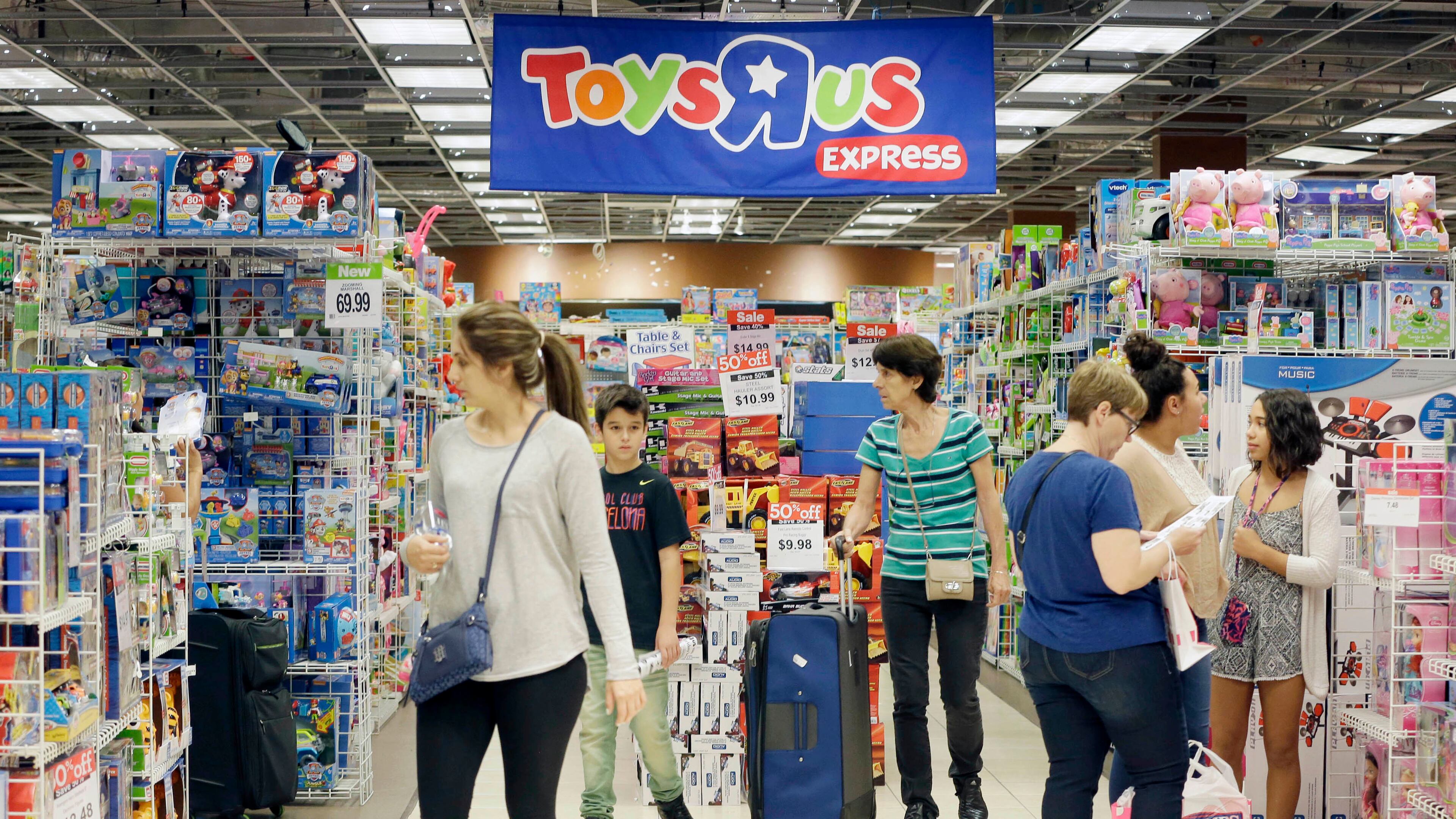 Shoppers shop in a Toys R Us store on Black Friday, Nov. 25, 2016, in Miami. Stores open their doors Friday for what is still one of the busiest days of the year, even as the start of the holiday season edges ever earlier. (AP Photo/Alan Diaz)