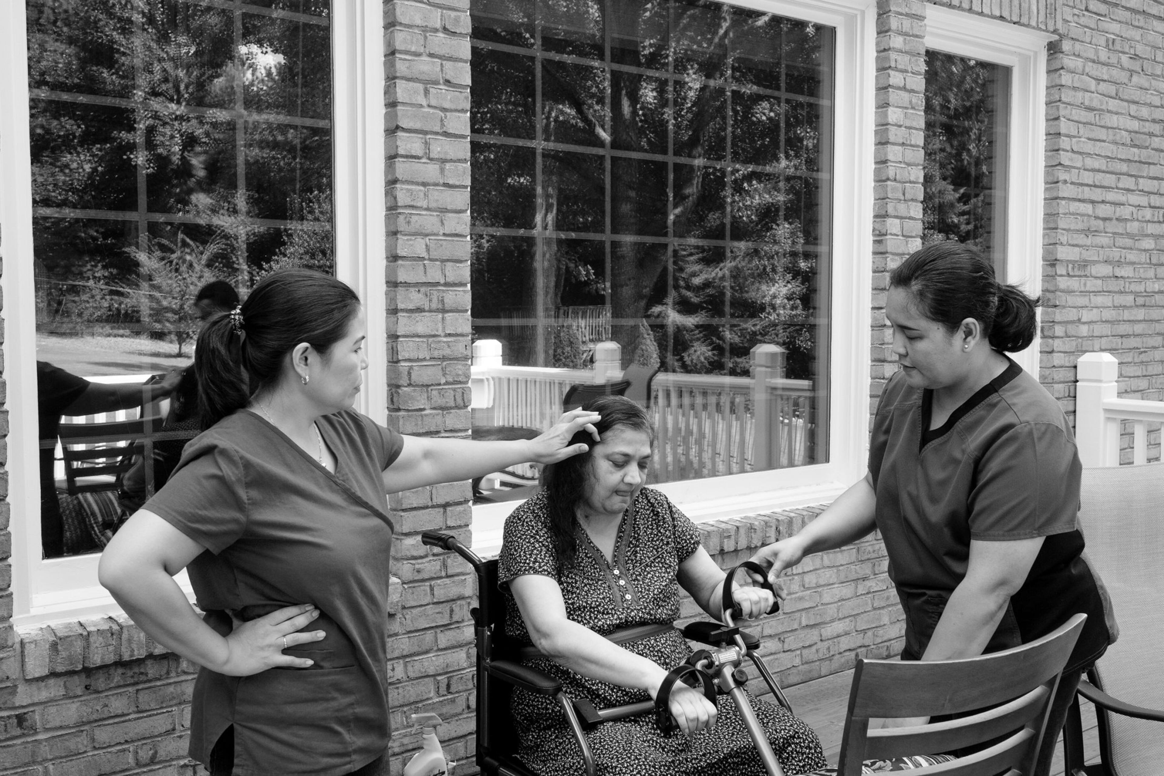 Over time, Rekha has needed more than one home care worker to support her. Jingky Yarnell, 47, (right) worked an evening job as a factory machine operator before arriving in the morning to work a few extra hours as a caregiver. After Pingul left, Jingky became the main caregiver and no longer works at the factory.