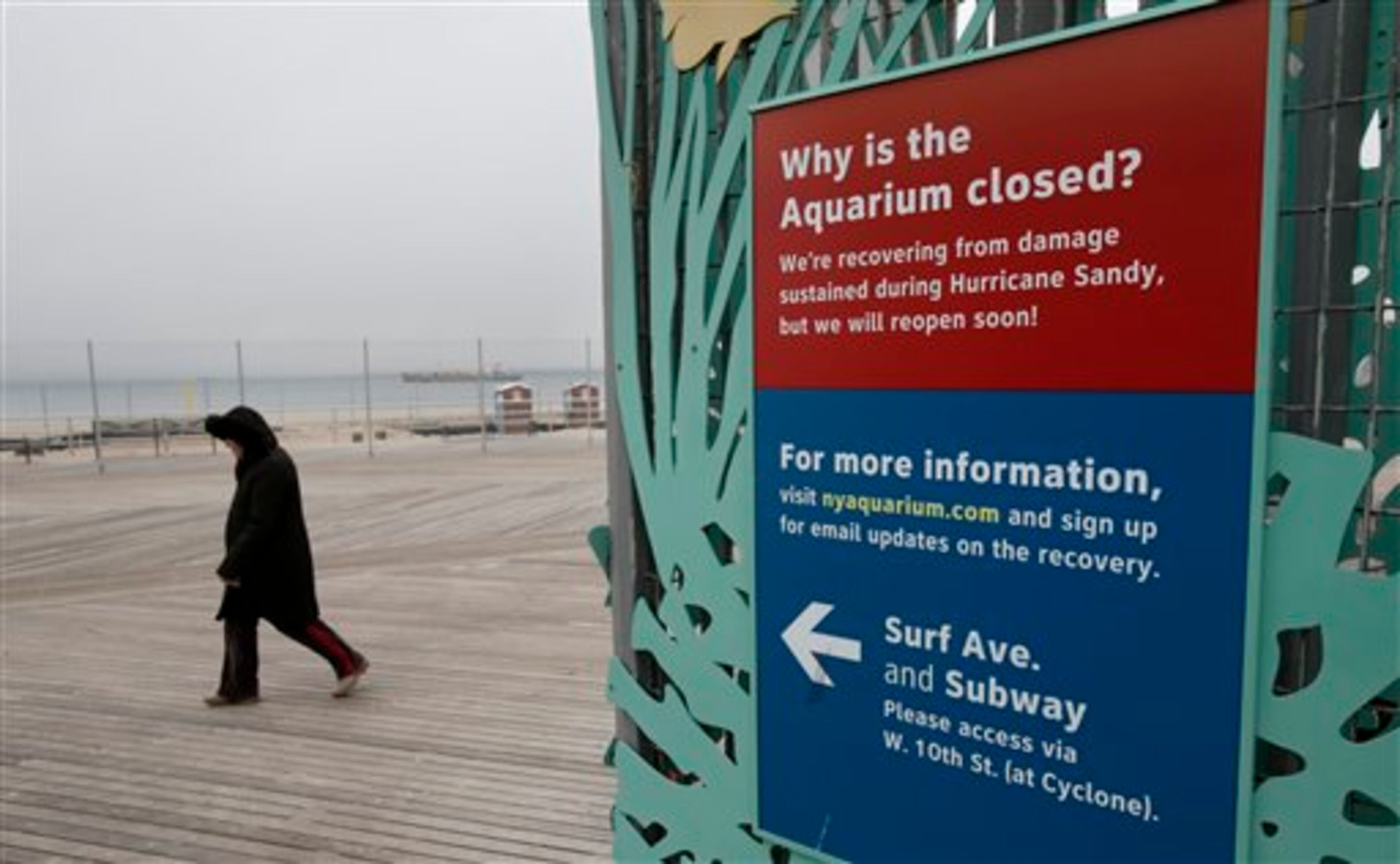 A woman walks past an entrance to the Wildlife Conservation Society's New York Aquarium in Coney Island, New York, Monday, March 25, 2013. (AP Photo/Seth Wenig)
