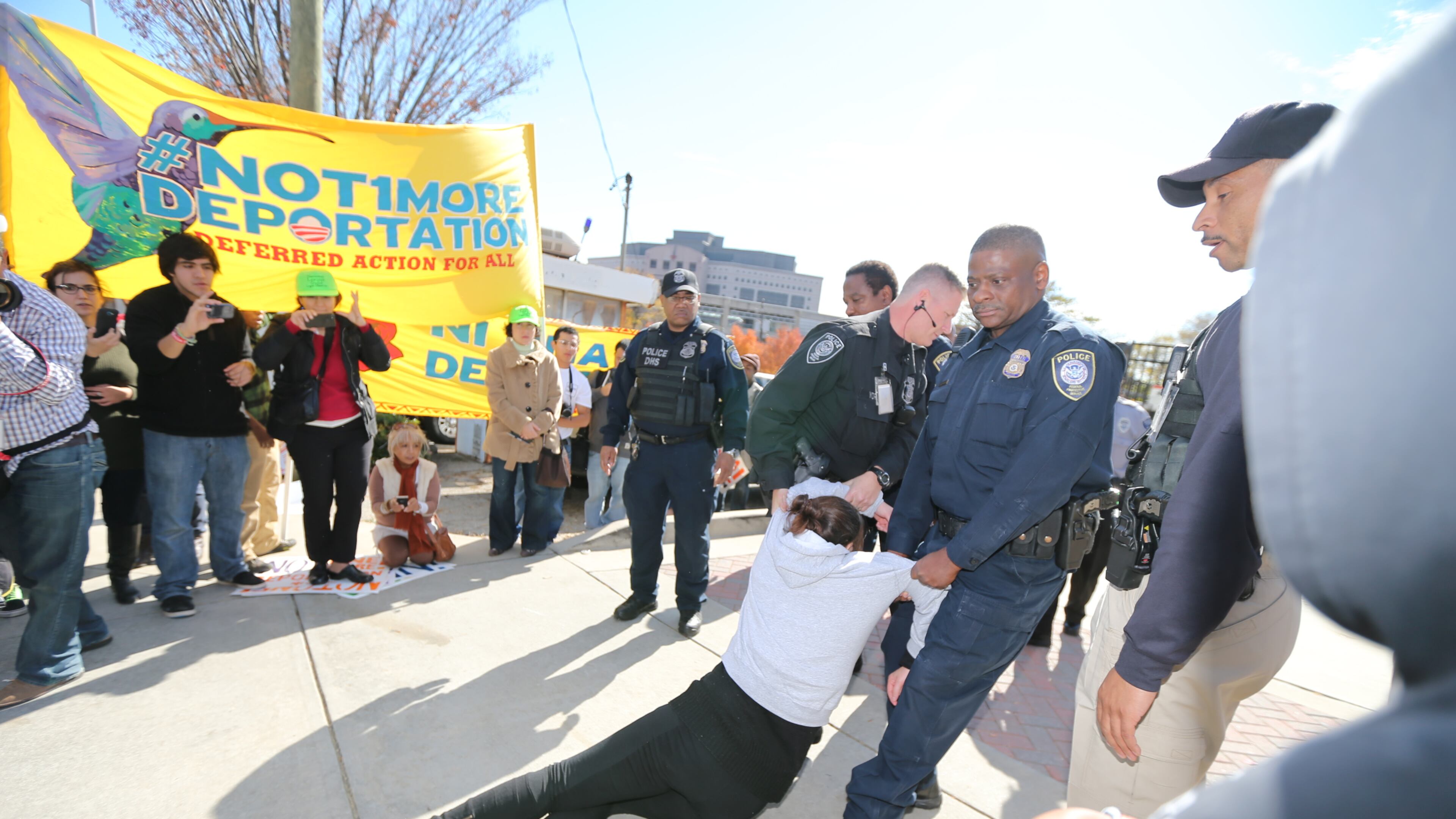 Activists locked themselves to the gates outside a federal government building in downtown Atlanta Tuesday as part of a boisterous demonstration against the Obama administration's immigration enforcement policies. Witnesses said authorities used bolt cutters to break the bicycle locks the activists used and took 14 people into custody just outside a building that houses U.S. Immigration and Customs Enforcement offices and federal immigration courtrooms. Here, officials arrest one of the protesters.