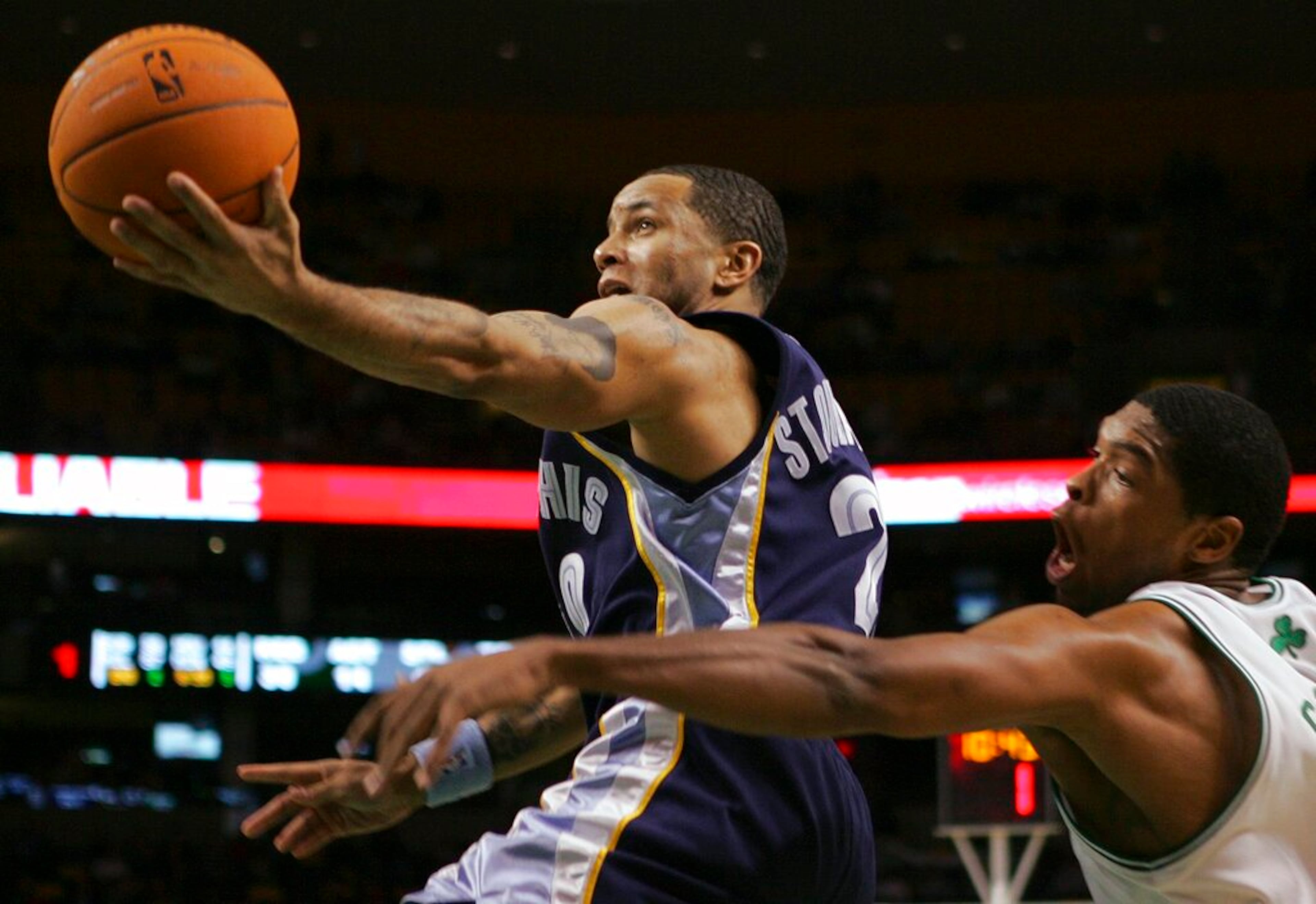 Memphis Grizzlies' Damon Stoudamire (20) goes up to shoot past Boston Celtics' Ryan Gomes, right, in the fourth quarter of an NBA basketball game, Wednesday, Dec. 6, 2006, in Boston. The Grizzlies won 98-96. (AP Photo/Michael Dwyer)