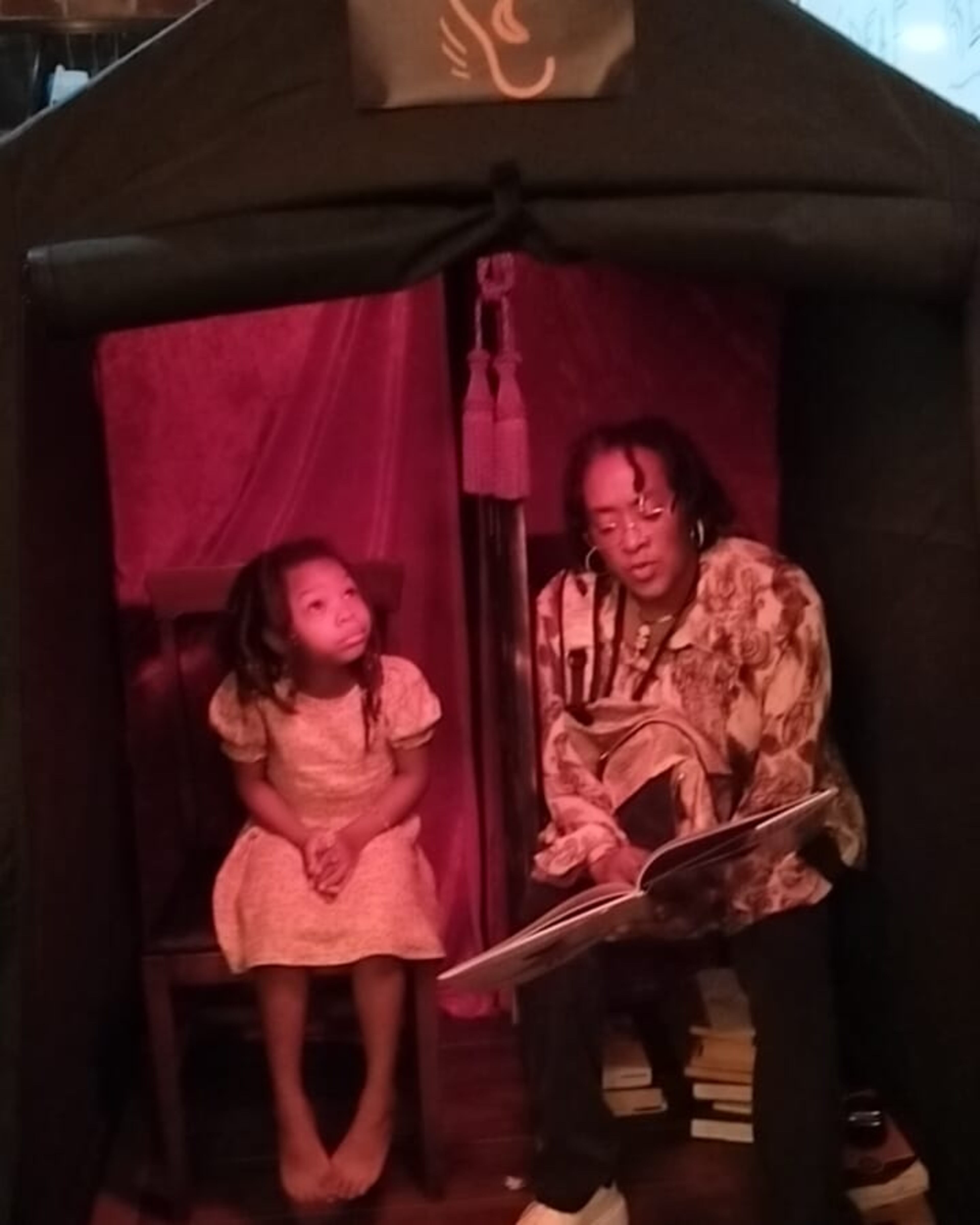 An art installation in which Theresa Davis read banned books in a confessional to children at 7 Stages Theatre.