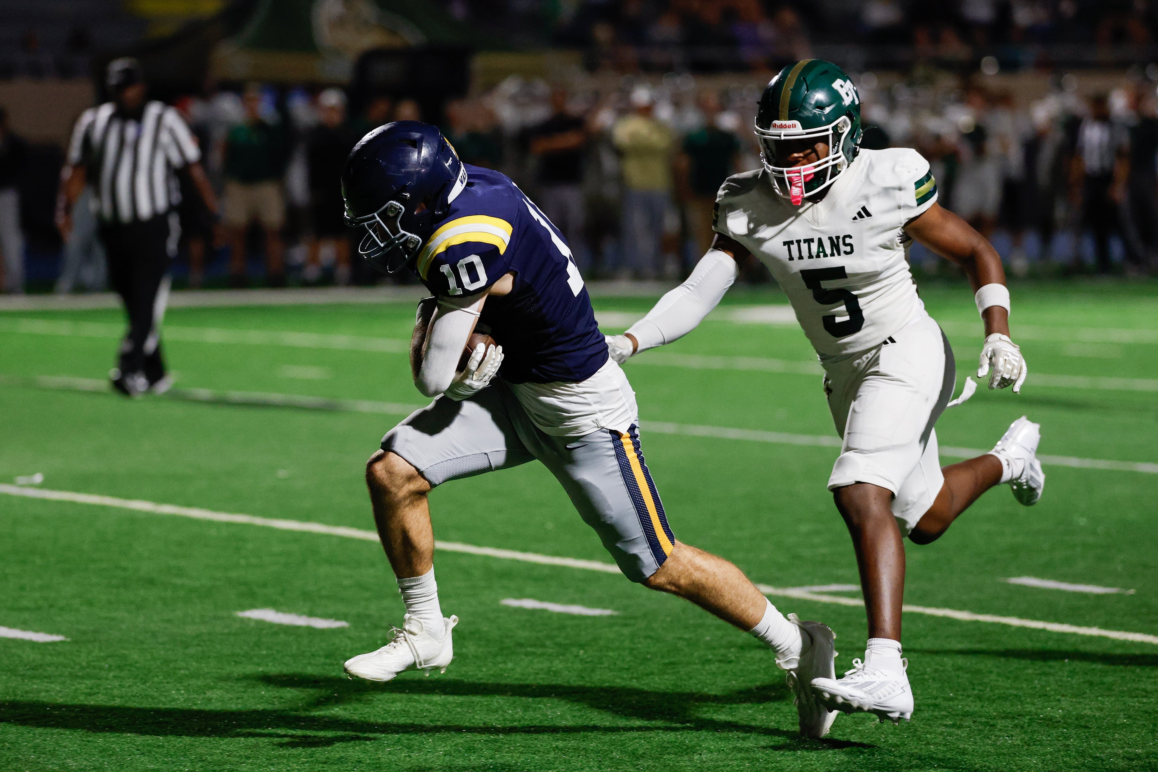 Marist’s Engin McCarthy (left) makes a pick-6 interception against Blessed Trinity’s Darin Bruce during their game on Friday, Sept. 25, 2026, in Atlanta. (Erik S. Lesser for the AJC)