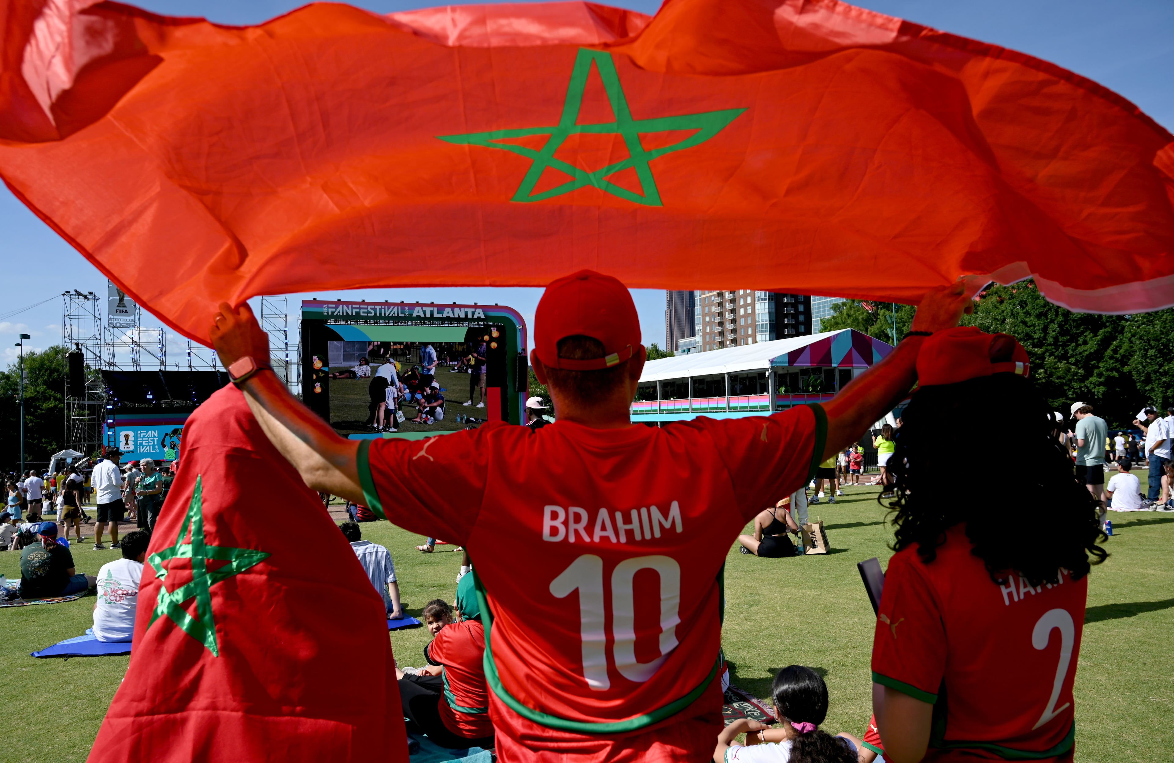 Local Moroccan fans holding their national flags gather for a watch party ahead of the match against Brazil at the FIFA Fan Festival in Centennial Olympic Park on Saturday, June 13, 2026, in Atlanta. (Hyosub Shin/AJC)