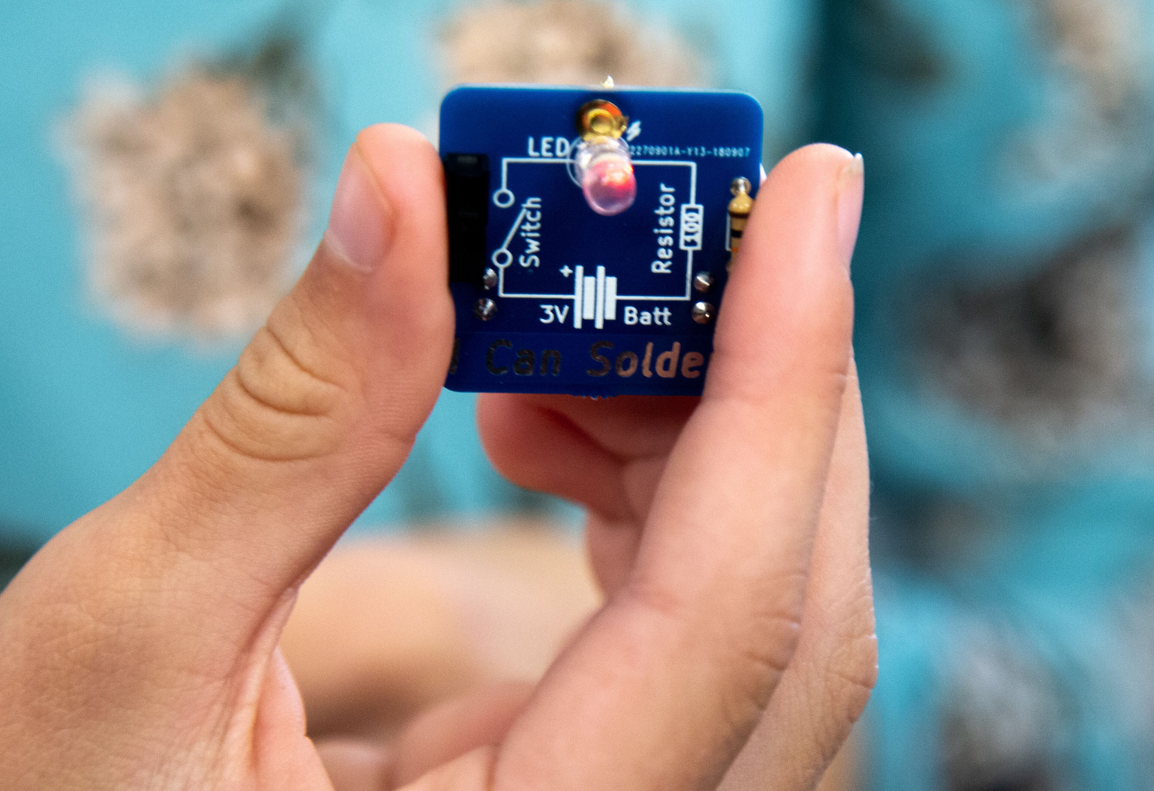 Josephine Kean holds up a lapel pin that lights up that she made during the Genius Camp in the ExLab at Georgia State University on Saturday, March 7, 2020. STEVE SCHAEFER / SPECIAL TO THE AJC