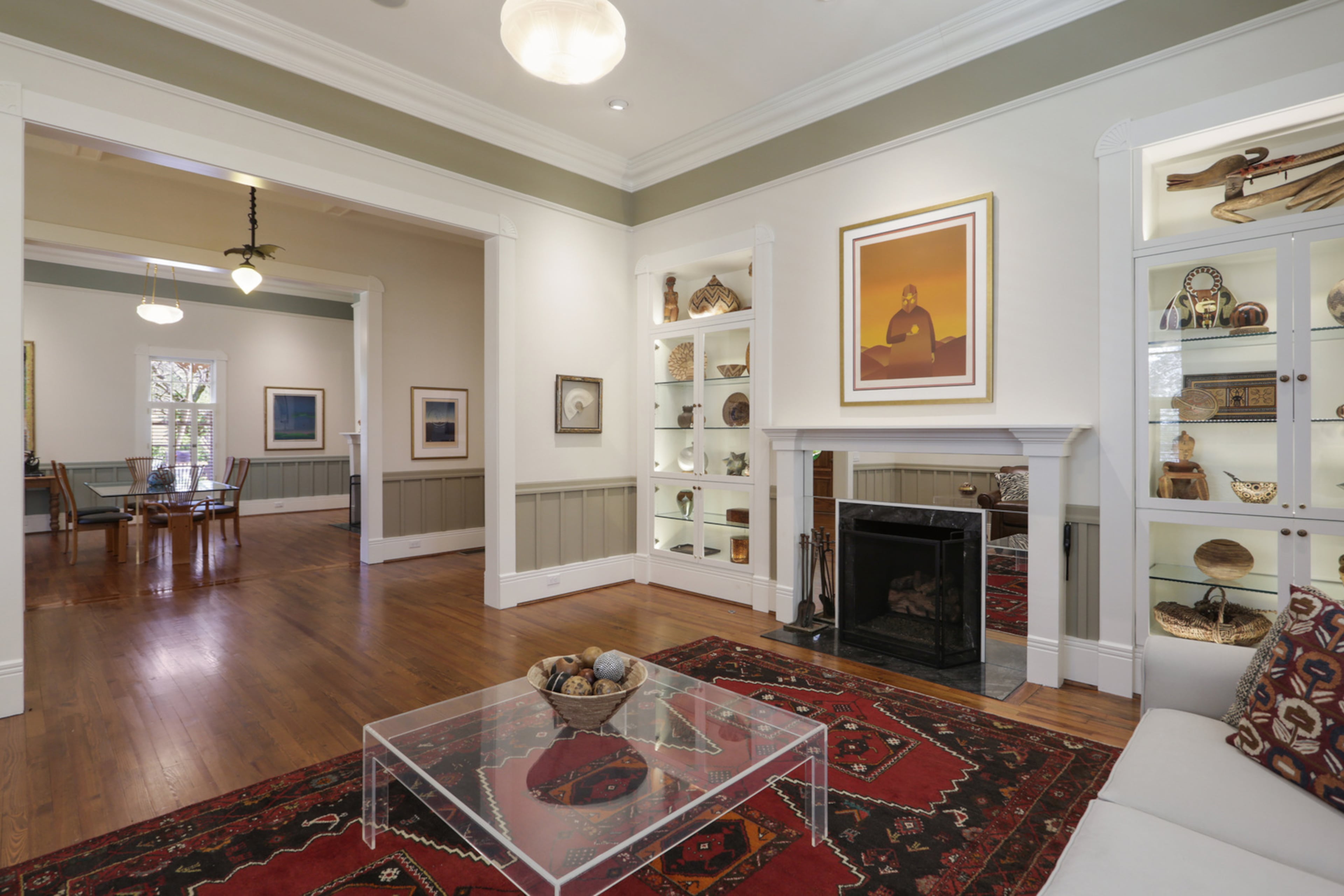 The living room boasts 12-foot ceilings, heart pine flooring, and an original fireplace that has been updated to gas. Text by Jill Huitron