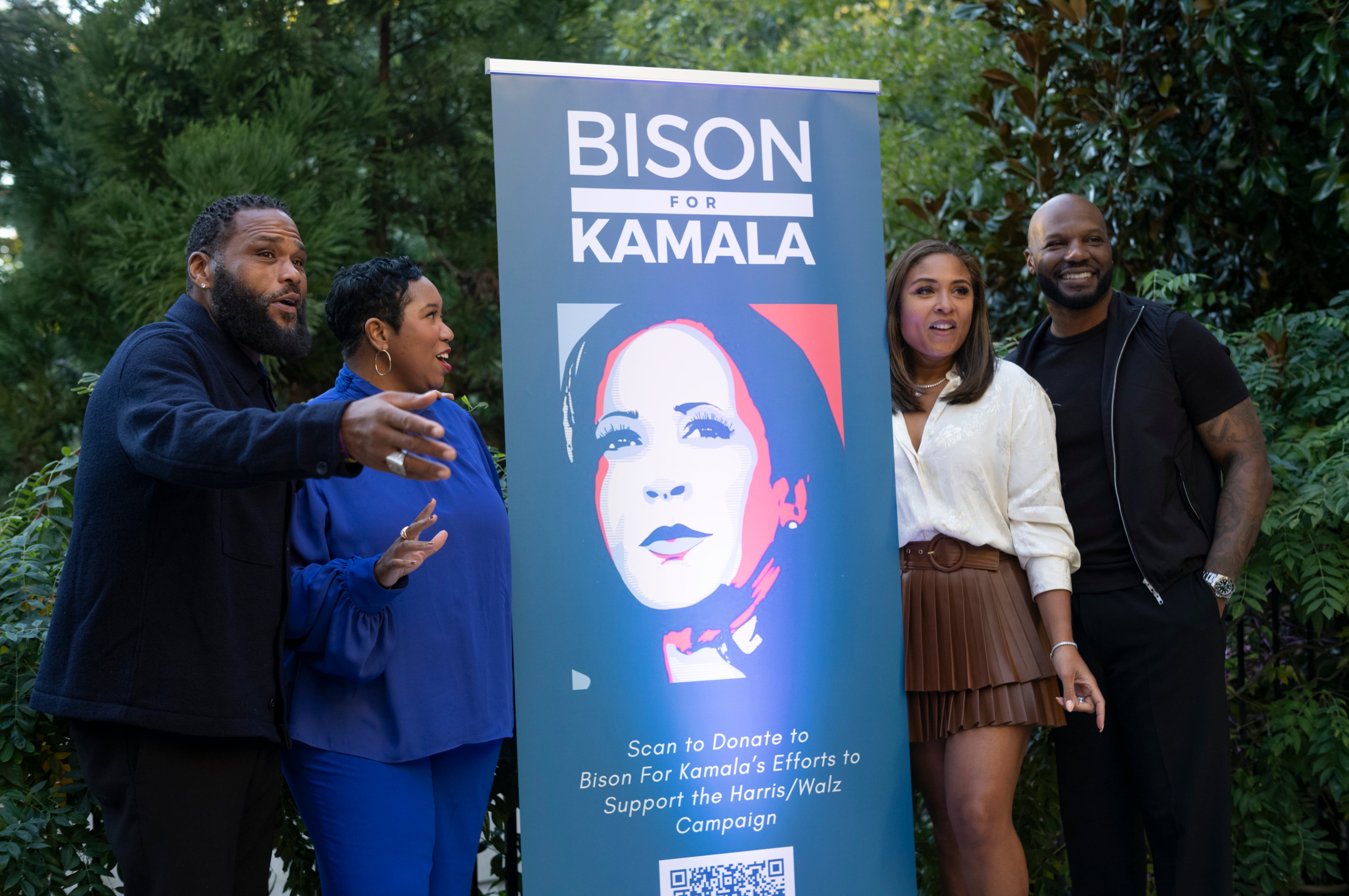 Actor Anthony Anderson (left), a Howard University alumnus who headlined “Bison for Kamala,” stands with others around a poster during the school’s 100th homecoming in Washington, Oct. 19, 2024. Kamala Harris, an alumna of the school, was running for U.S. president at the time. (Cheriss May/The New York Times)