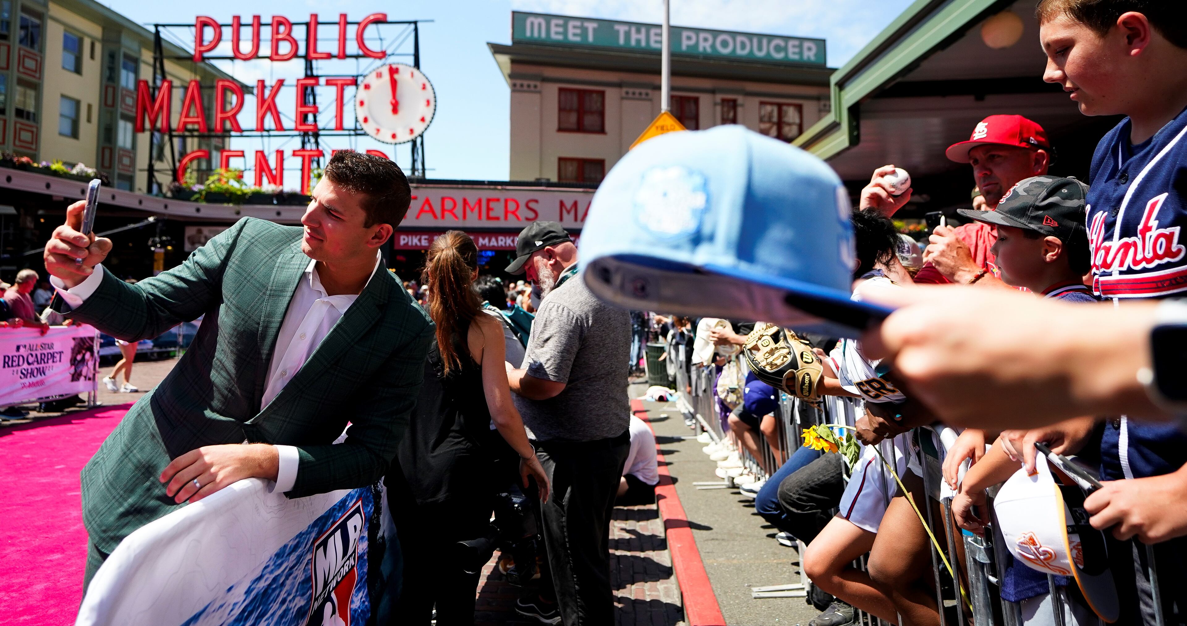 Austin Riley takes a photo with a fan during the baseball All-Star Game red carpet show Tuesday, July 11, 2023, in Seattle. (AP Photo/Lindsey Wasson)