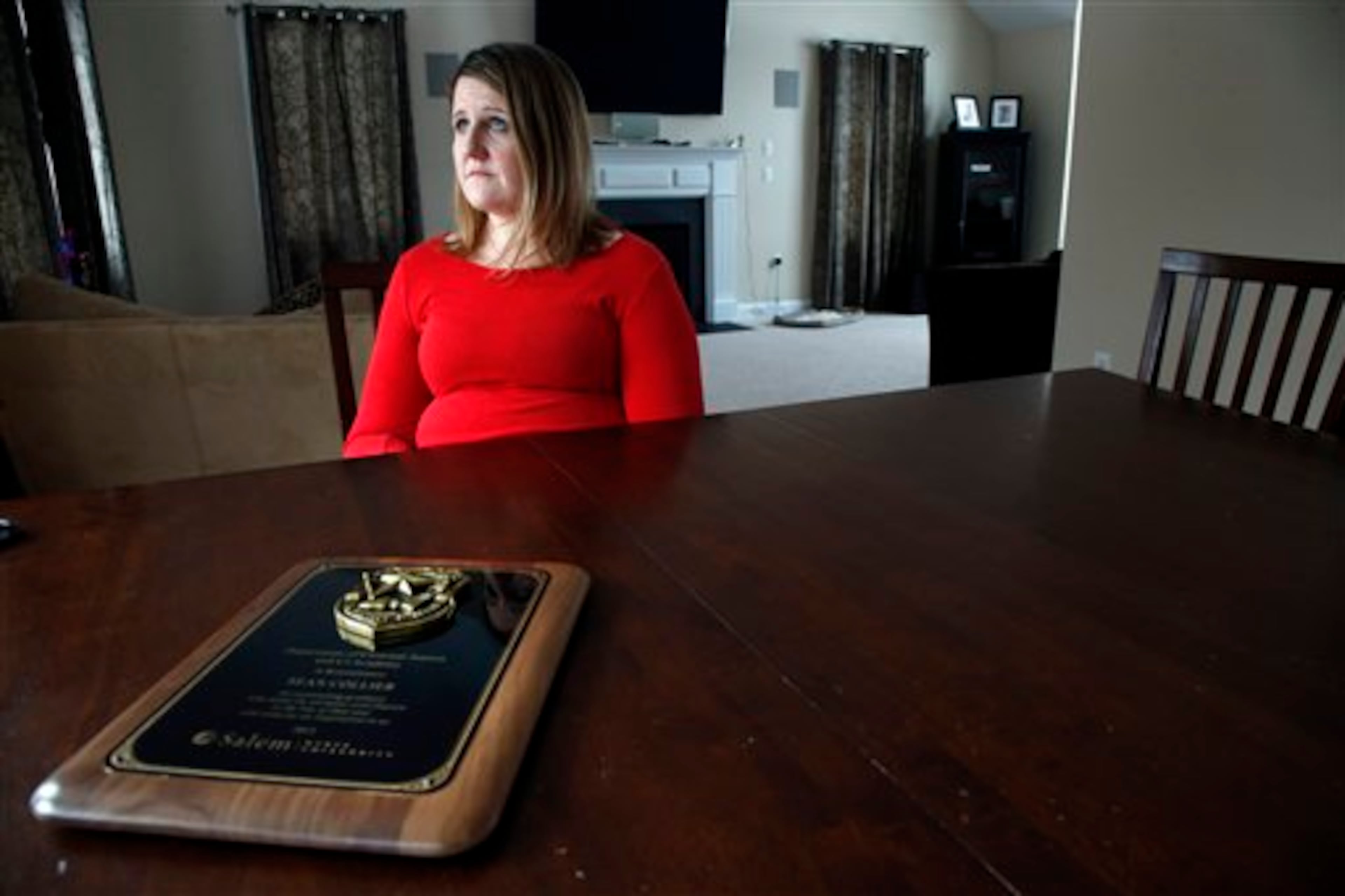 In this March 14, 2014 photo, Nicole Lynch, sister of slain Massachusetts Institute of Technology police officer Sean Collier, speaks during an interview at her home in Dracut, Mass. Collier was allegedly killed by the two suspects in the Boston Marathon bombings on April 19, 2013. Lynch still mourns her brother and will be at the 2014 race with Team Collier Strong to raise money for a scholarship fund to put one person a year through law enforcement training. (AP Photo/Elise Amendola)