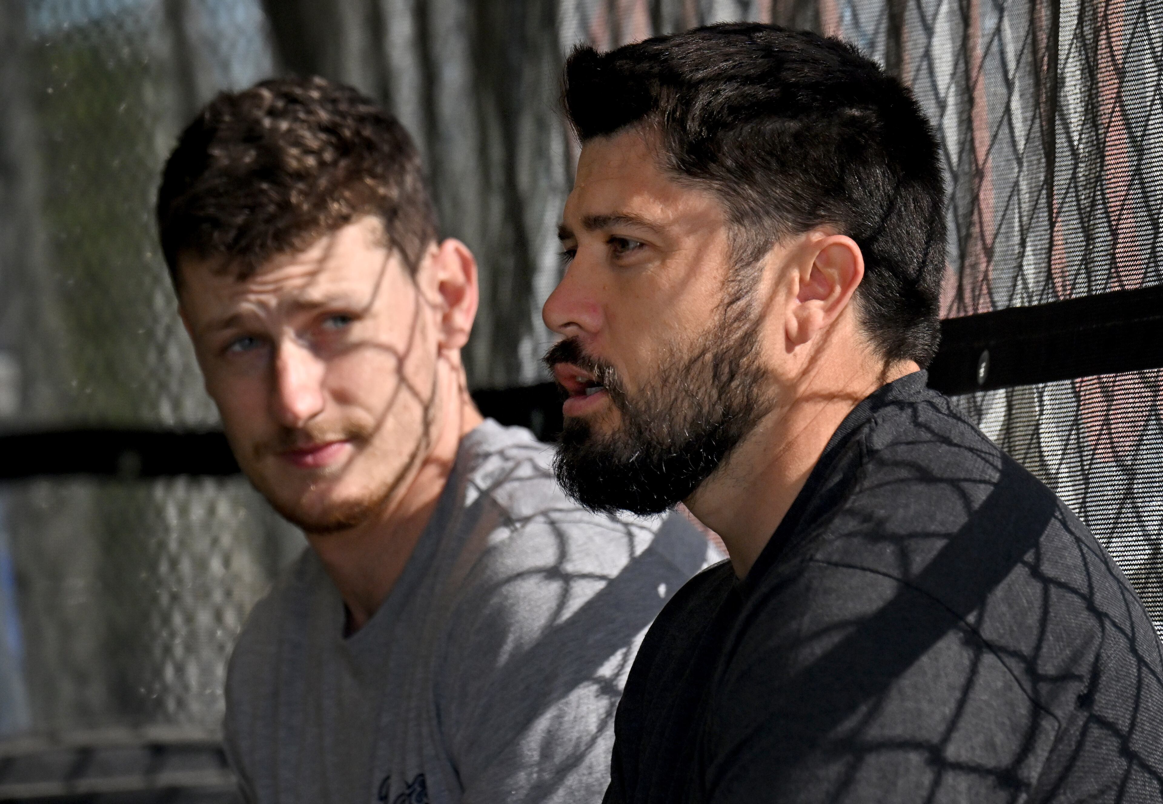 Braves catchers Sean Murphy (left) and Travis d'Arnaud chat while taking batting practice during spring training at CoolToday Park in North Port, Florida on Wednesday, Feb., 14, 2024. (Hyosub Shin / Hyosub.Shin@ajc.com)