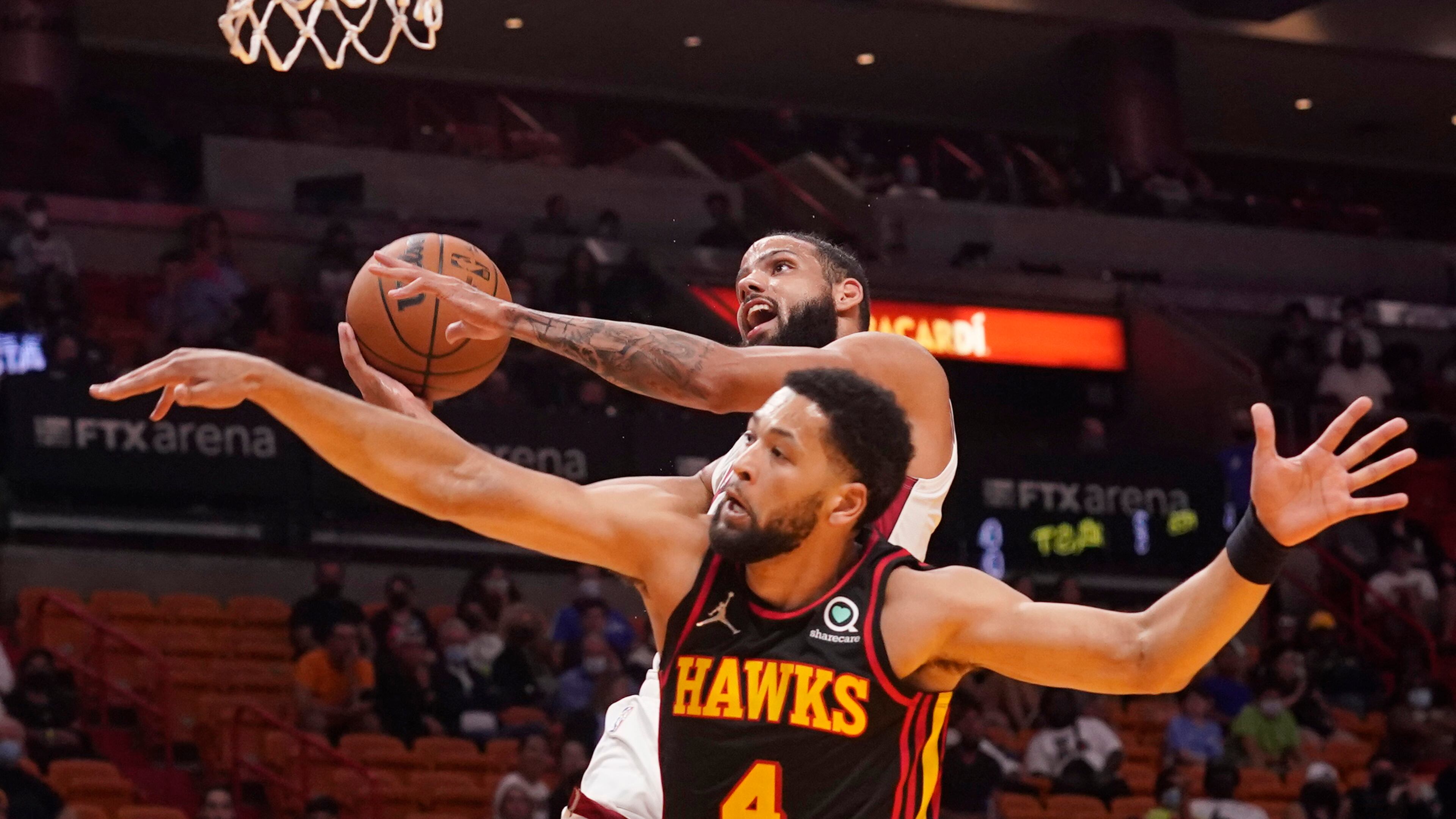 Miami Heat forward Caleb Martin (16) drives to the basket as Hawks guard Skylar Mays (4) defends during the second half of a preseason NBA game, Monday, Oct. 4, 2021, in Miami. (Marta Lavandier/AP)