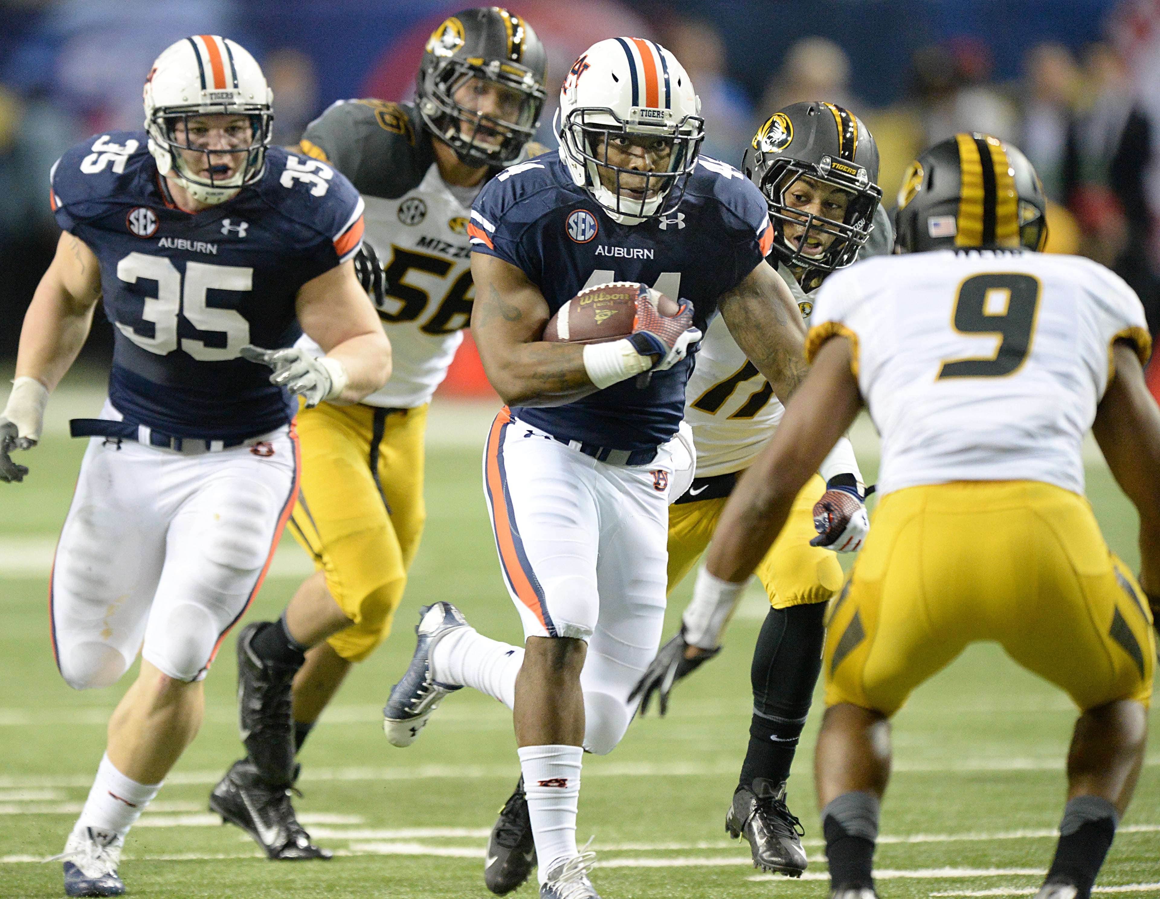 Auburn Tigers running back Cameron Artis-Payne (44) carries the ball against the Missouri Tigers during the second half of the SEC Championship game at Georgia Dome on Saturday, December 7, 2013. Auburn Tigers won 59-42. HYOSUB SHIN / HSHIN@AJC.COM