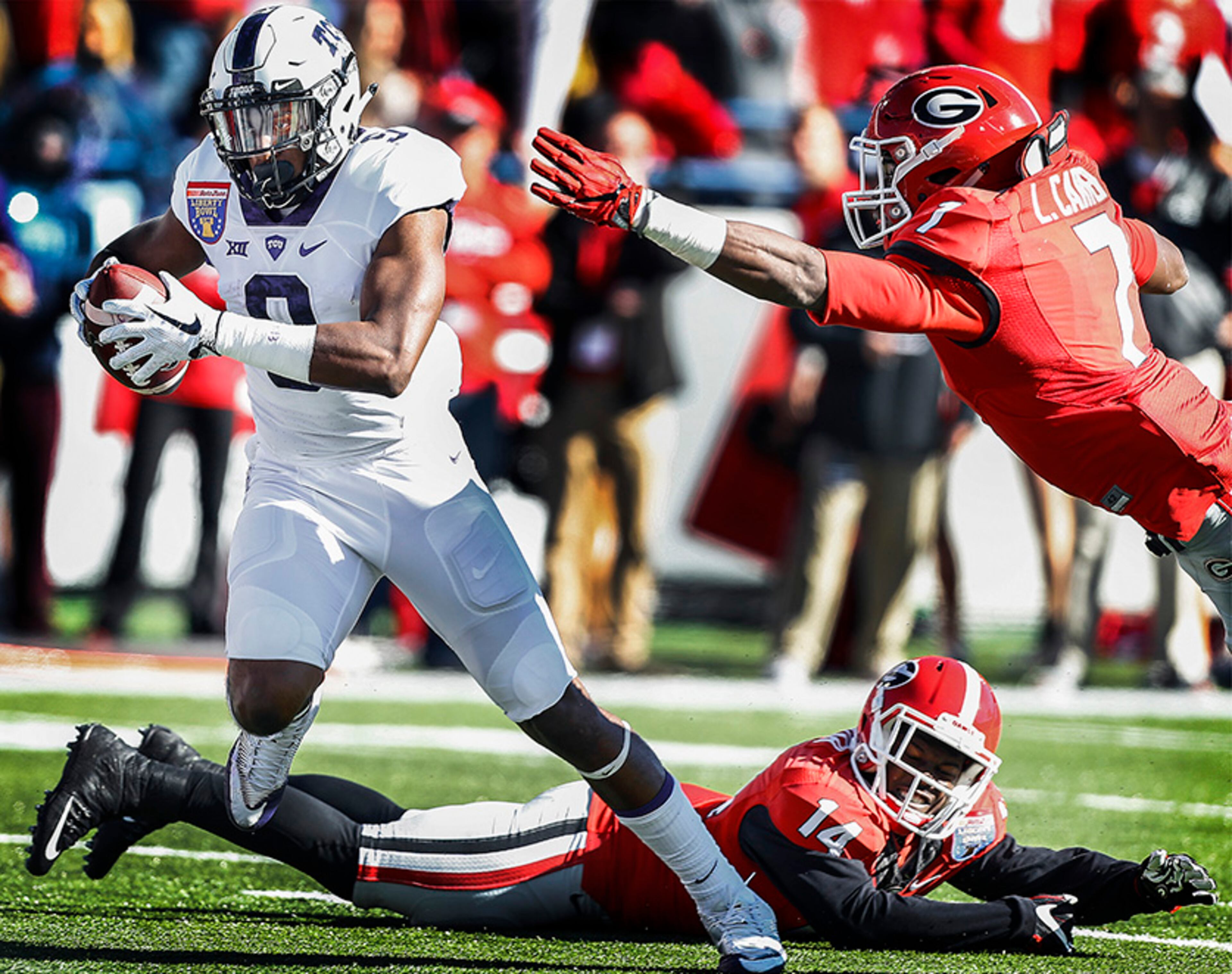 TCU receiver John Diarse, left, scrambles past the Georgia defense for a 10-yard touchdown reception during the second quarter of the Liberty Bowl NCAA college football game, Friday, Dec. 30, 2016, in Memphis, Tenn. (Mark Weber/The Commercial Appeal via AP)