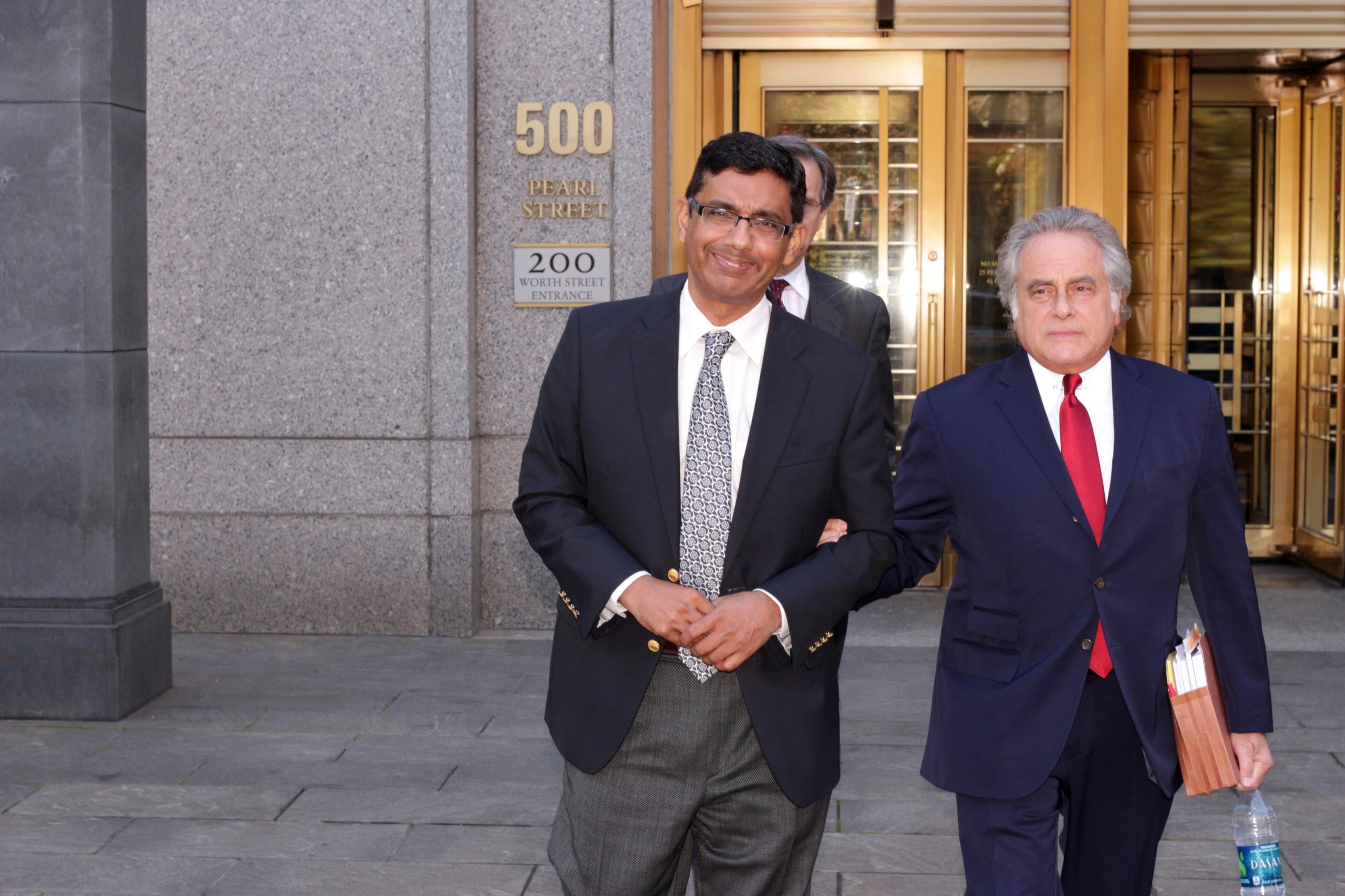 Dinesh D'Souza, the conservative commentator and documentarian, after his sentencing for a campaign finance violation in New York, Sept. 23, 2014. D'Souza, who is set to receive a presidential pardon for the felony conviction, has spent almost four decades in a cycle of provocation and controversy that has made him, at times, a hero of the right.