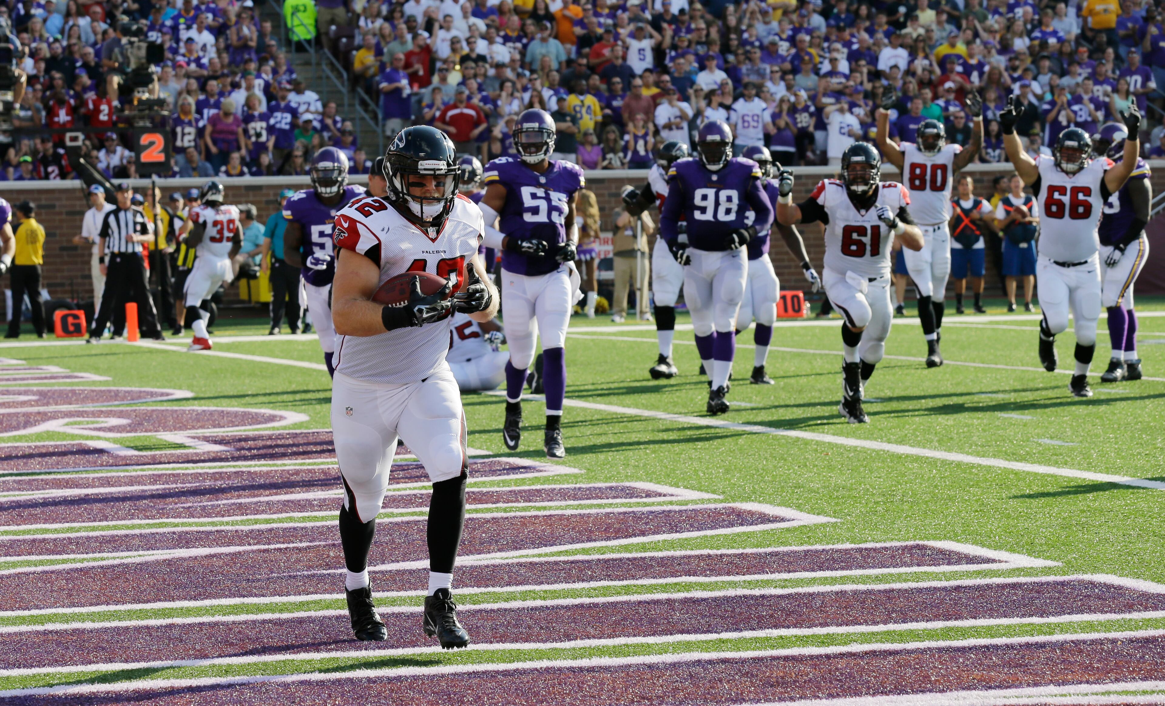 Atlanta Falcons fullback Patrick DiMarco (42) catches a 1-yard touchdown pass during the first half of an NFL football game against the Minnesota Vikings, Sunday, Sept. 28, 2014, in Minneapolis. (AP Photo/Ann Heisenfelt)