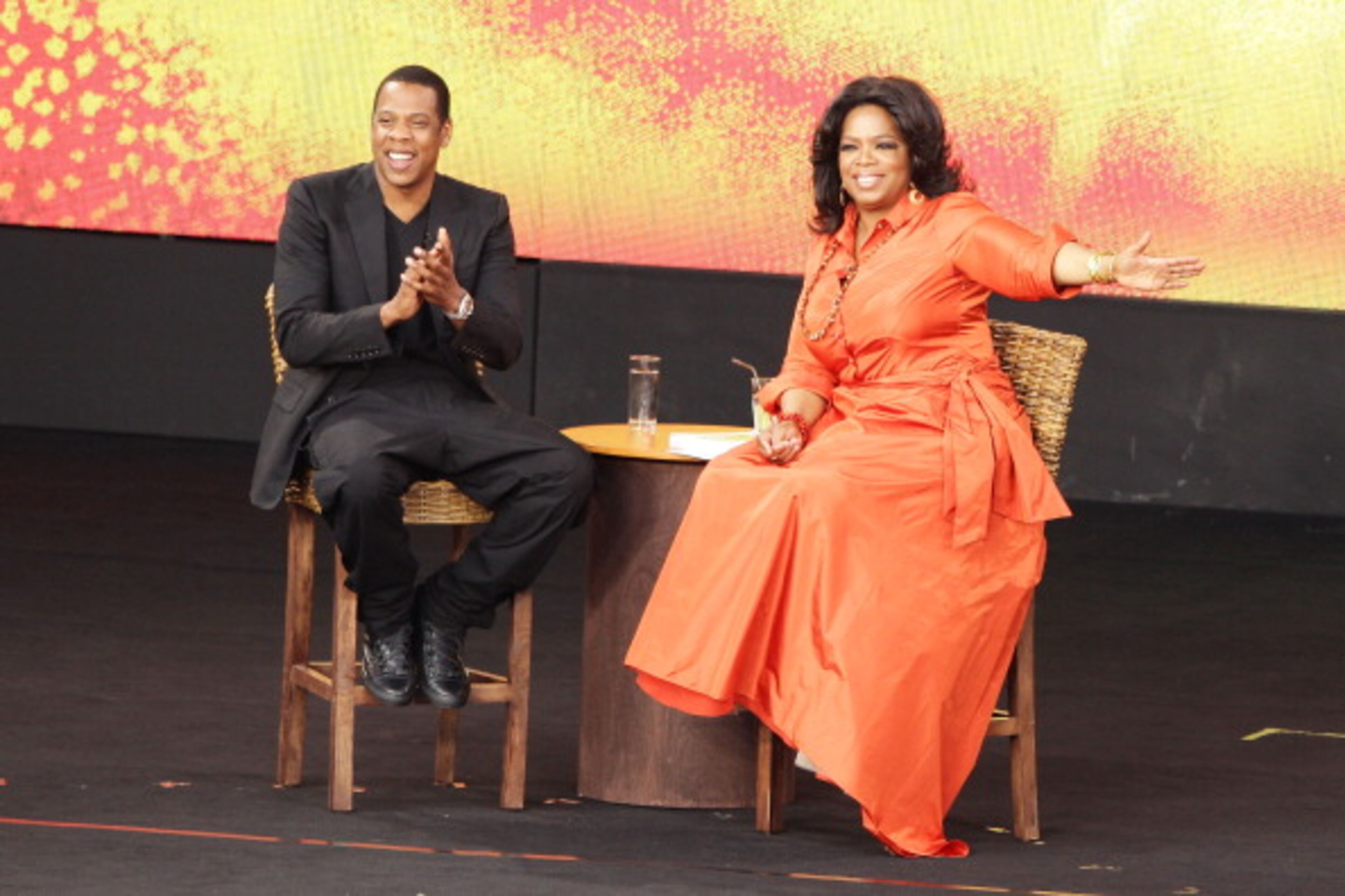 SYDNEY, AUSTRALIA - DECEMBER 14: Oprah Winfrey and Jay-Z talk on stage during the first taping of the "Oprah Winfrey Show" at the Sydney Opera House on December 14, 2010 in Sydney, Australia. 12,000 audience members were selected from 350,000 applicants to participate in two tapings of "The Oprah Winfrey Show" at the Sydney Opera House. Oprah descended on Australia last week with 302 super fans from the US, Canada and Jamaica to produce four shows for the 25th and final season of the program. the shows will air in the US and Australia in January 2011. (Photo by Brendon Thorne/Getty Images)