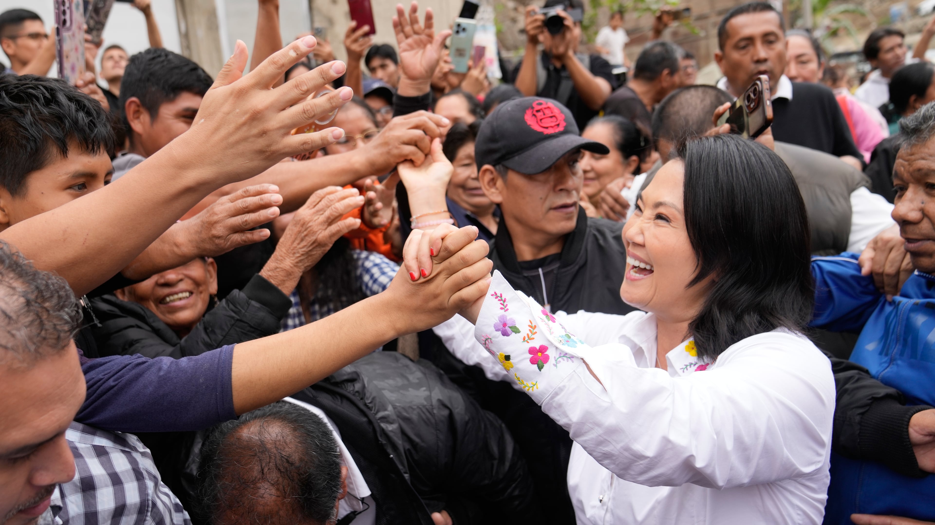 Presidential candidate Keiko Fujimori, of the Popular Force party, greets supporters before voting in the presidential runoff election in Lima, Peru, Sunday, June 7, 2026. (AP Photo/Martin Mejia)