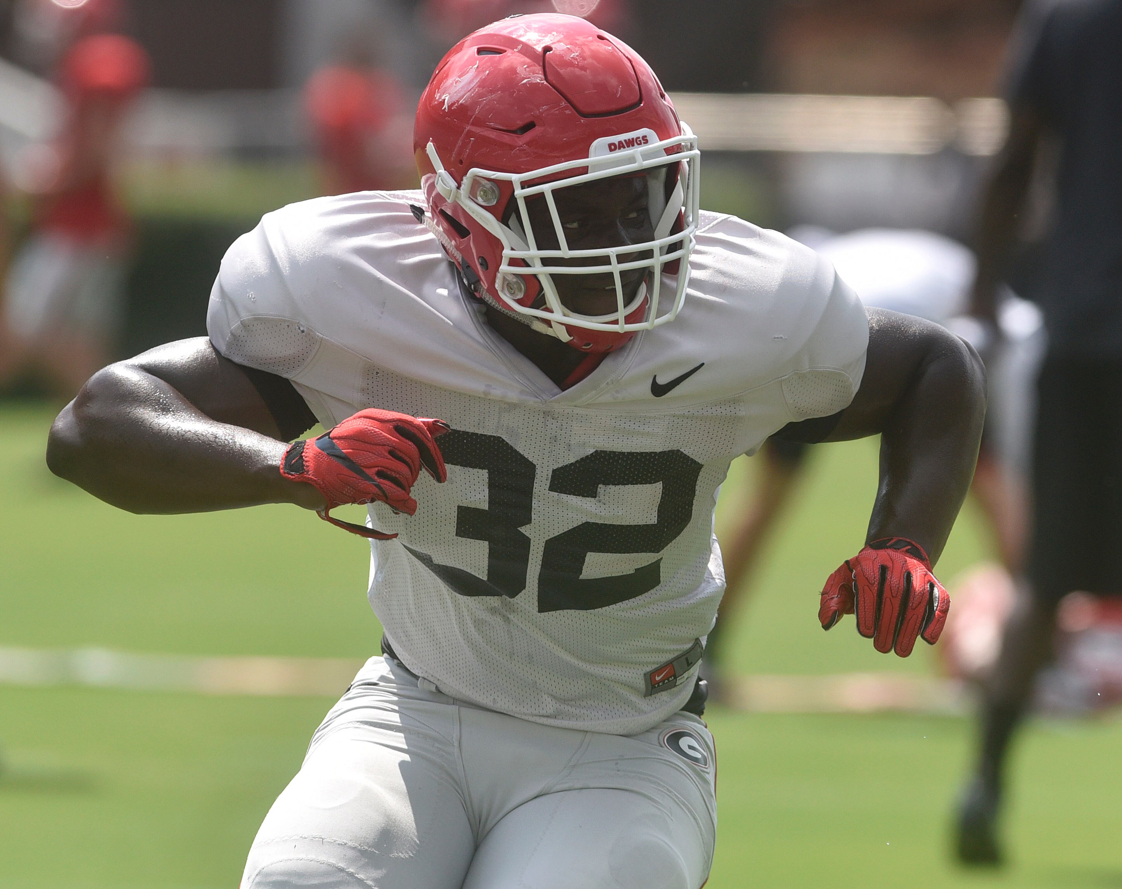 Georgia linebacker Monty Rice (32) runs a practice drill during the annual UGA Fan Day at Sanford Stadium on Saturday, Aug 5, 2017 in Athens, Ga.
(RICHARD HAMM)