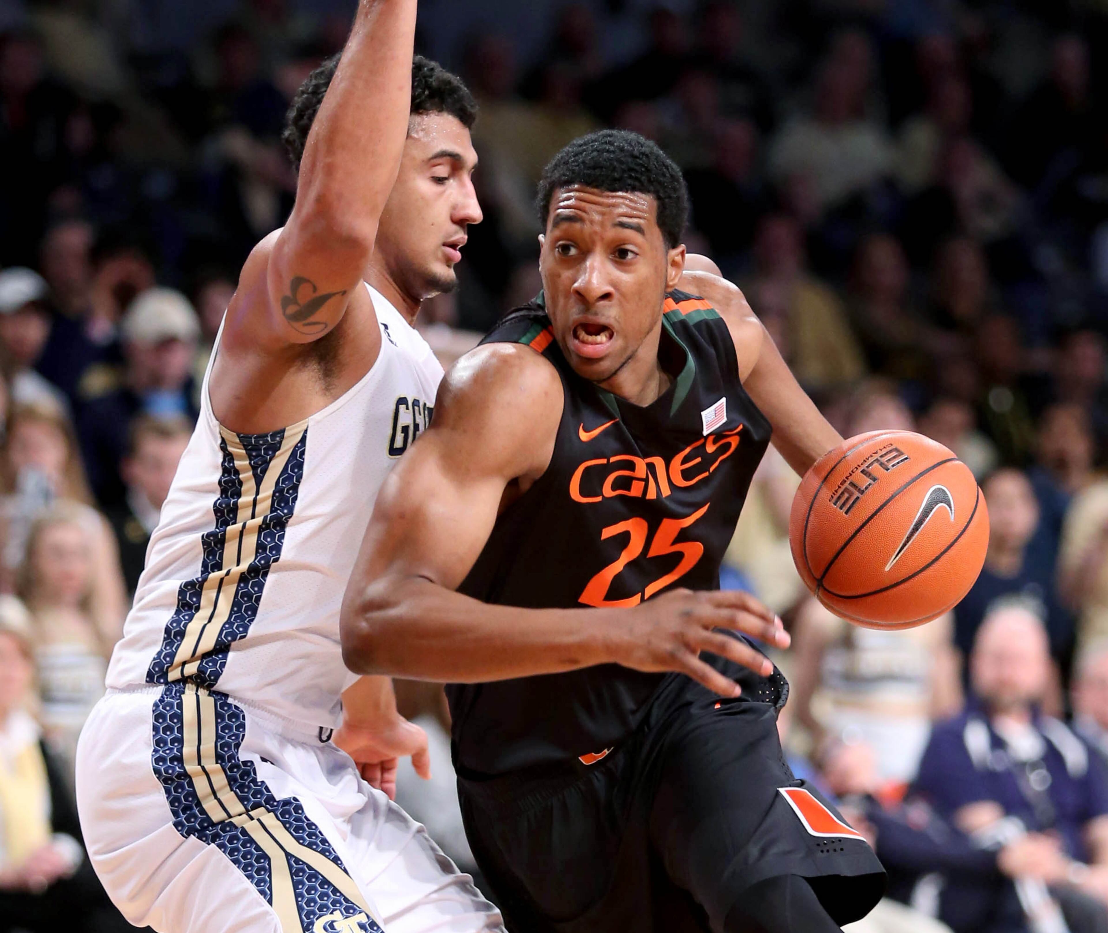 Miami guard Garrius Adams (25) drives against the defense of Georgia Tech guard Chris Bolden in the first half of an NCAA college basketball game, Saturday, Jan. 18, 2014, in Atlanta.