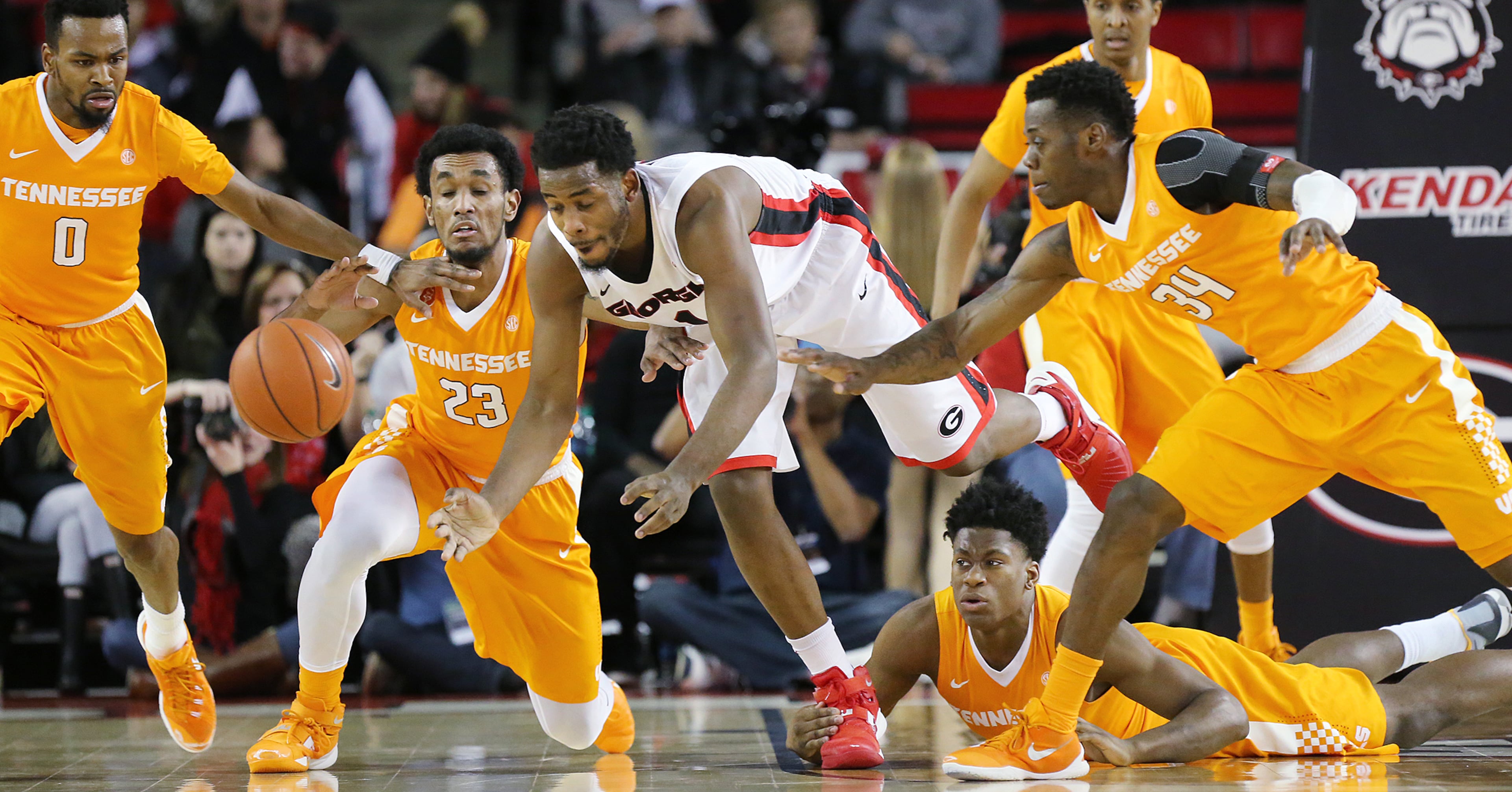 Tennessee defenders Kevin Punter (from left), Derek Reese, Admiral Schofield, and Devon Baulkman steal the ball from Georgia forward Yante Maten during the first half in a basketball game on Wednesday, Jan. 13, 2016, in Athens. Curtis Compton / ccompton@ajc.com