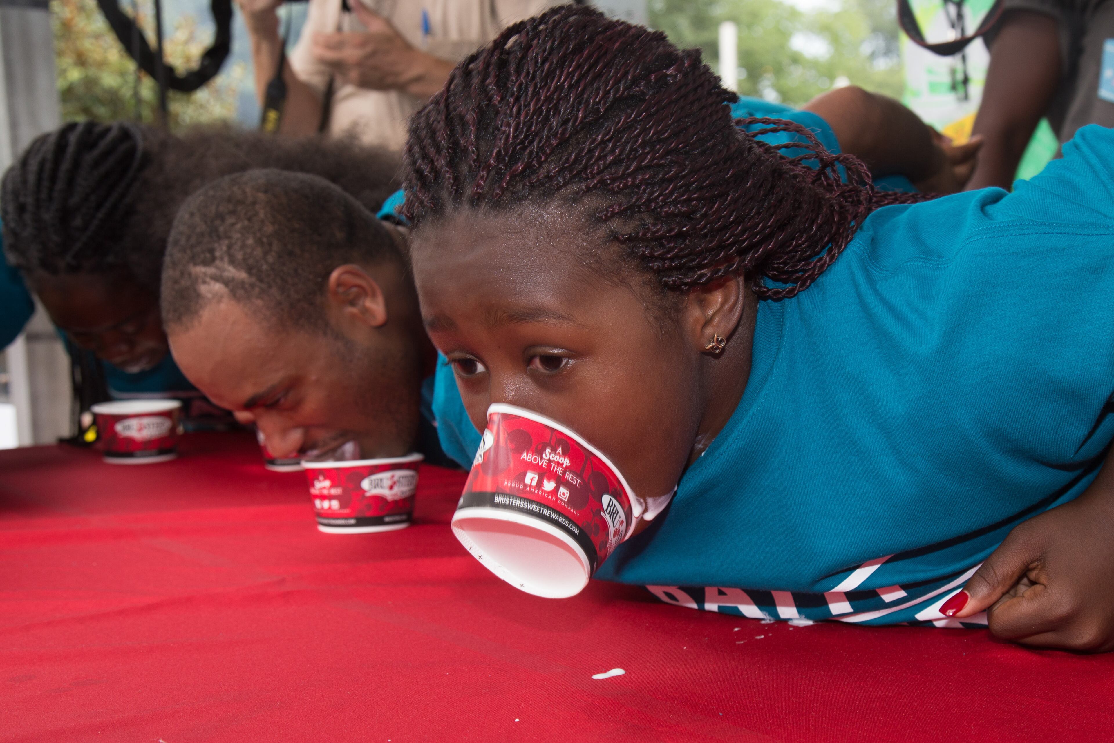Priosh Taylor tries to get the last of her ice cream out of the cup during the ice cream eating contest at the Ice Cream Festival in Piedmont Park Saturday, July 23 2016. STEVE SCHAEFER / SPECIAL TO THE AJC