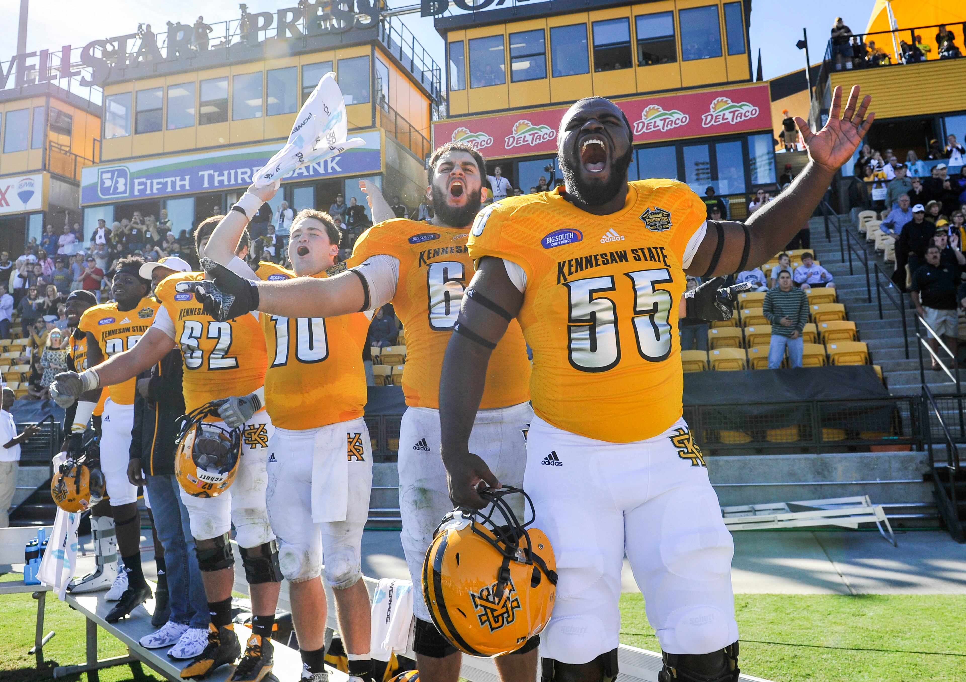Kennesaw State players including Brandon Sutton (55), C.J. Collins, second from right, and Trey White (10) celebrate on the sideline Saturday, Oct. 17, 2015, in Kennesaw, Ga. Kennesaw State won 12-7. (Photo/John Amis)