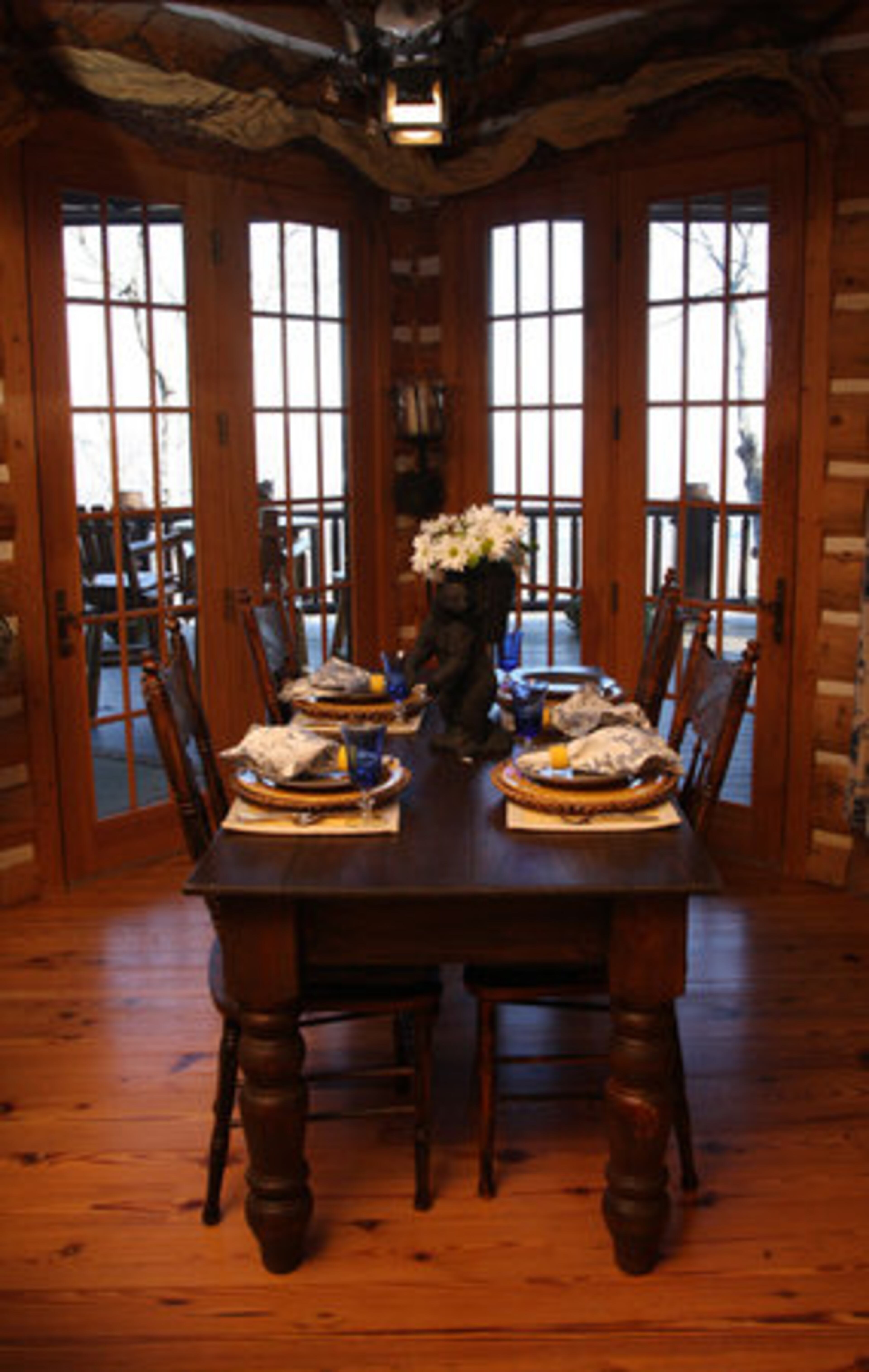 The hearth room off the kitchen includes a fireplace and a custom-made breakfast table. "We tried to build in spaces to give it character and make it extra functional. We wanted a home that was really liveable," Joan Prater said. Reclaimed heart pine floors from South Georgia are found throughout the home. "They get this really beautiful patina," she said of the floors, which are about 150 years old.