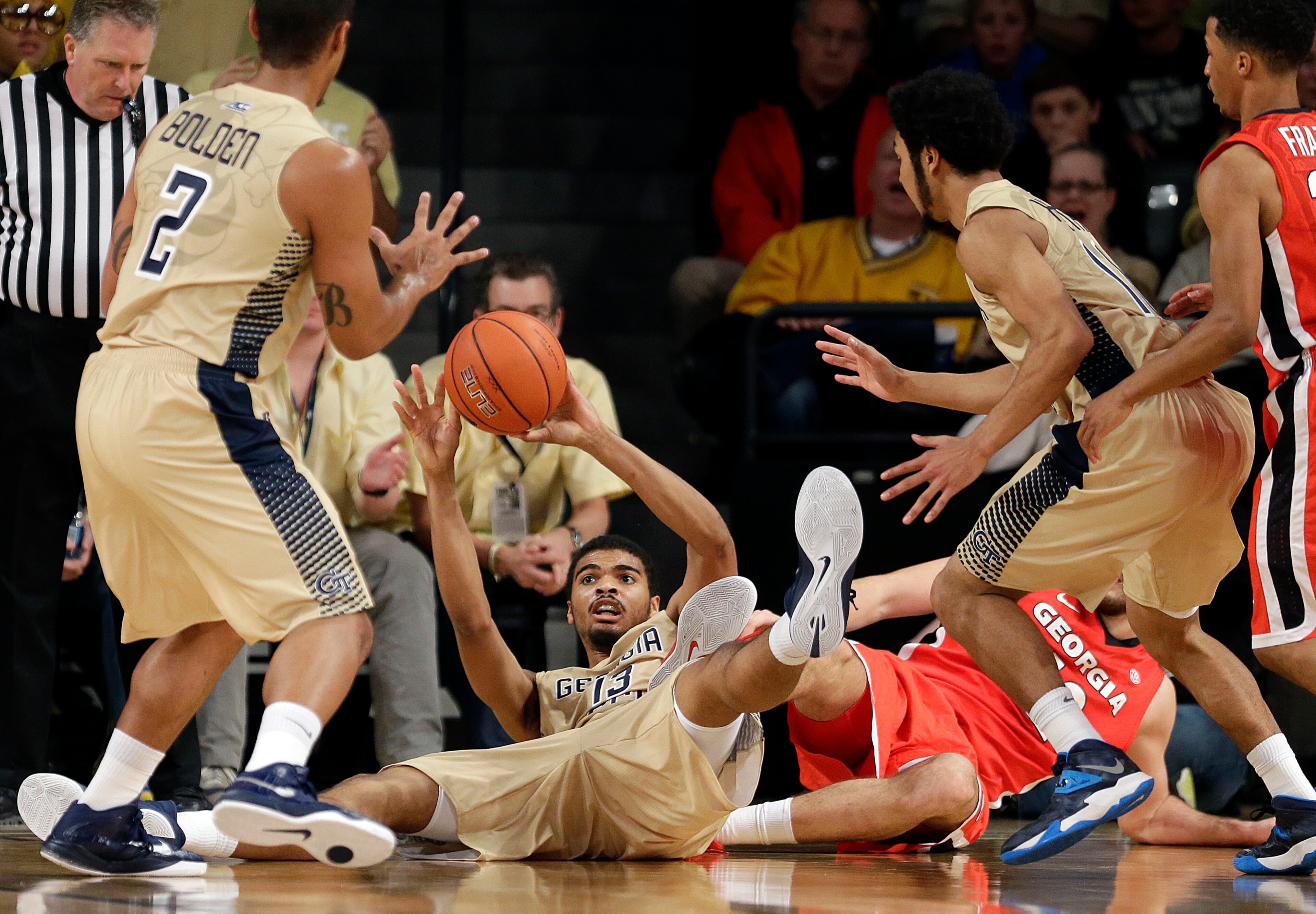 Georgia Tech's Robert Sampson, bottom, passes the ball to teammate Chris Bolden after colliding with Georgia's Nemanja Djurisic, bottom right, for a loose ball in the second half of an NCAA college basketball game, Friday, Nov. 14, 2014, in Atlanta. (AP Photo/David Goldman)