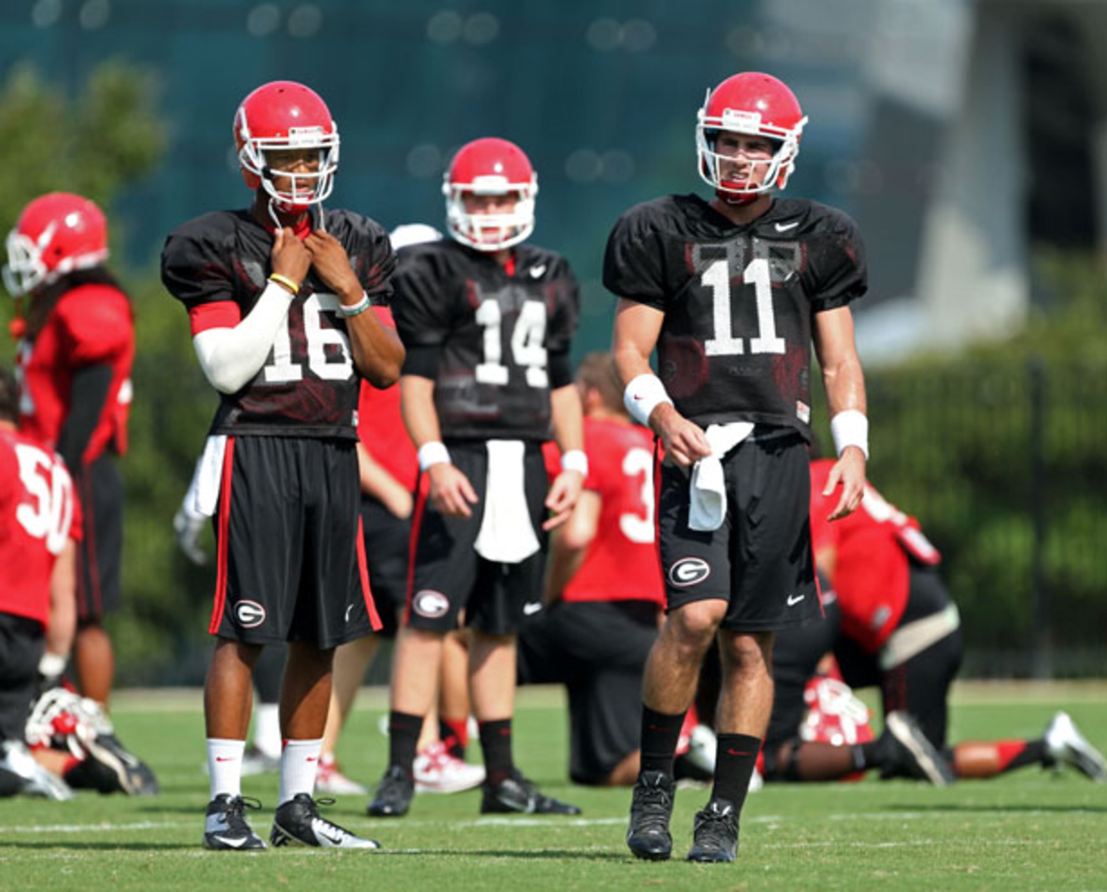 University of Georgia quarterbacks from left to right; Christian LeMay (16), Hutson Mason (14), and Aaron Murray (11) take a break during preseason practice at the University of Georgia Friday afternoon in Athens, Ga., August 23, 2013. JASON GETZ / JGETZ@AJC.COM