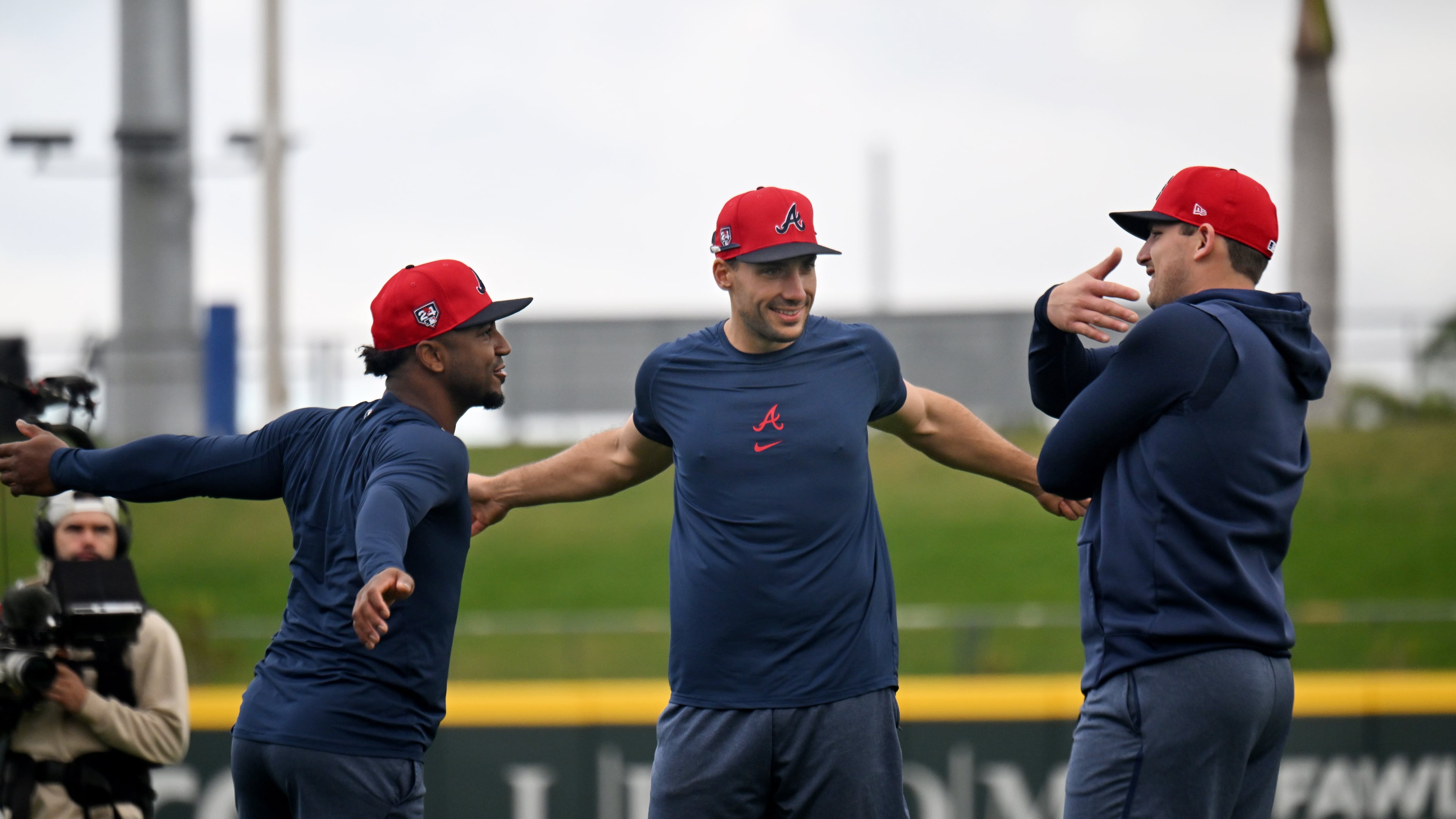 Braves second baseman Ozzie Albies (from left), first baseman Matt Olson and third baseman Austin Riley chat as they warm up during spring training workouts at CoolToday Park, Monday, February, 19, 2024, in North Port, Florida. (Hyosub Shin / Hyosub.Shin@ajc.com)