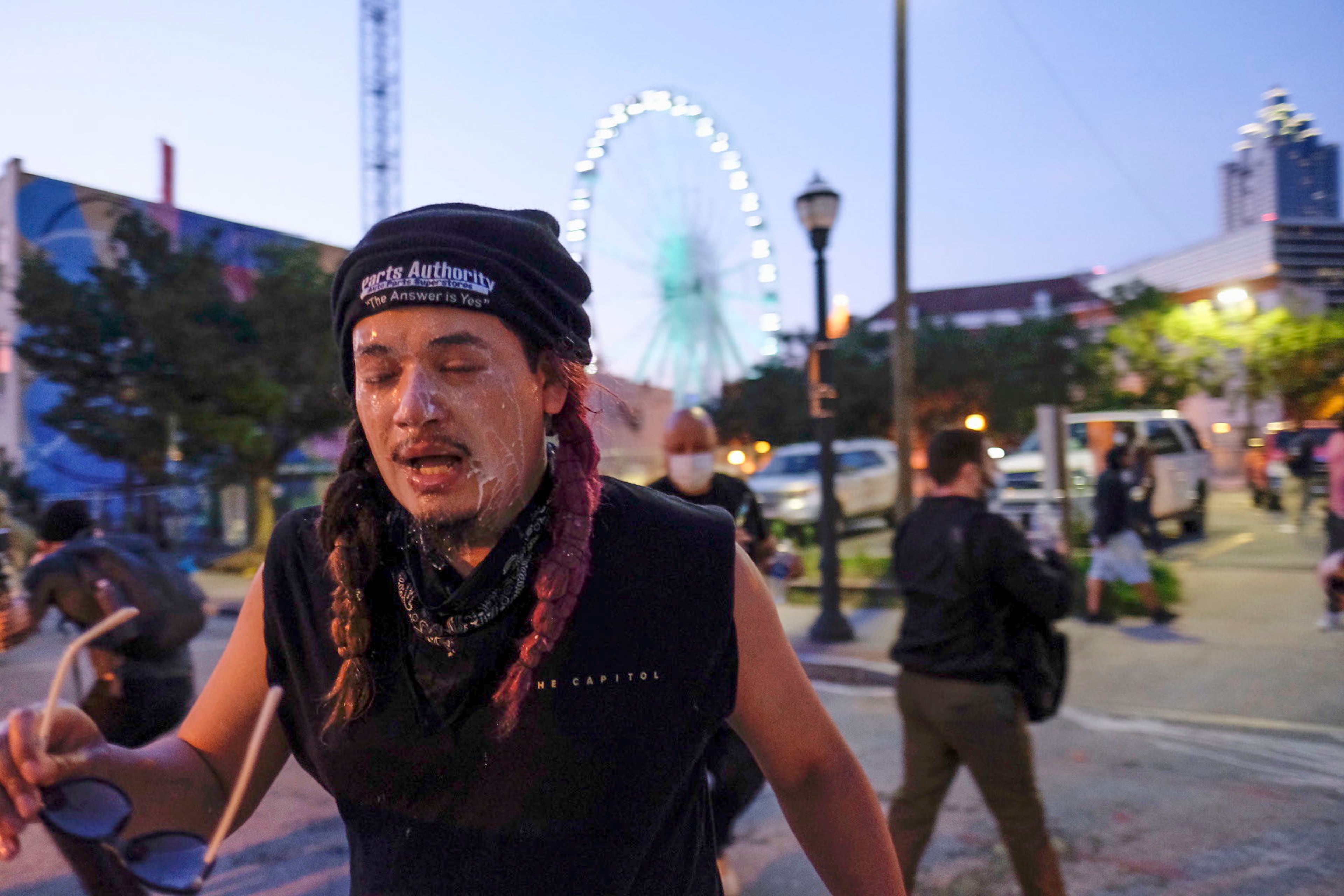 June 2, 2020 - Atlanta - Protestors dodge tear gas and police after the 9pm curfew in downtown Atlanta as protests continued for a fourth day. Protests over the death of George Floyd in Minneapolis police custody continued around the United States, as his case renewed anger about others involving African Americans, police and race relations. Ben Gray for the Atlanta Journal Constitution