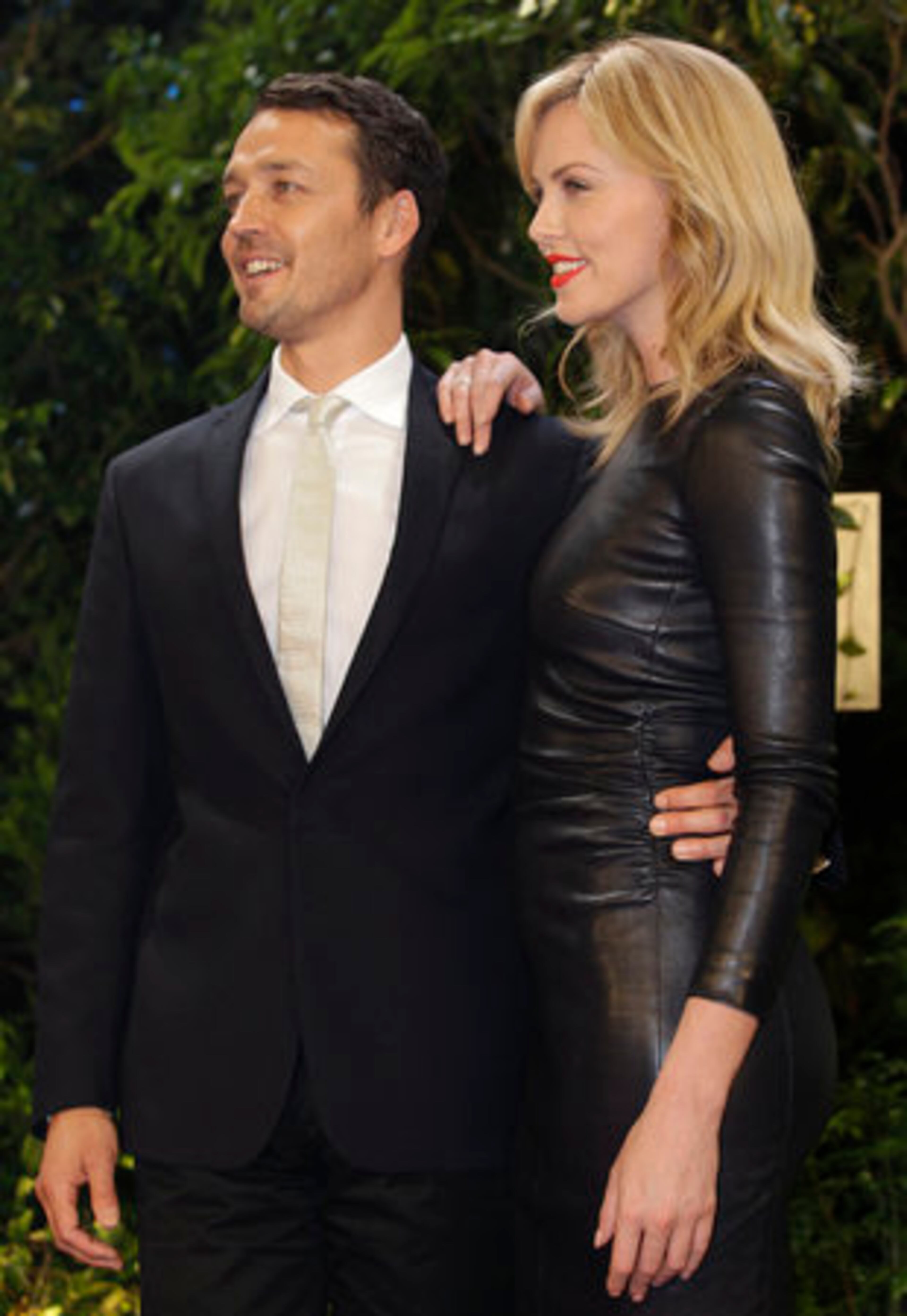 The 36-year-old Charlize Theron, appearing with director Rupert Sanders, was decked out in a The Row black leather dress.