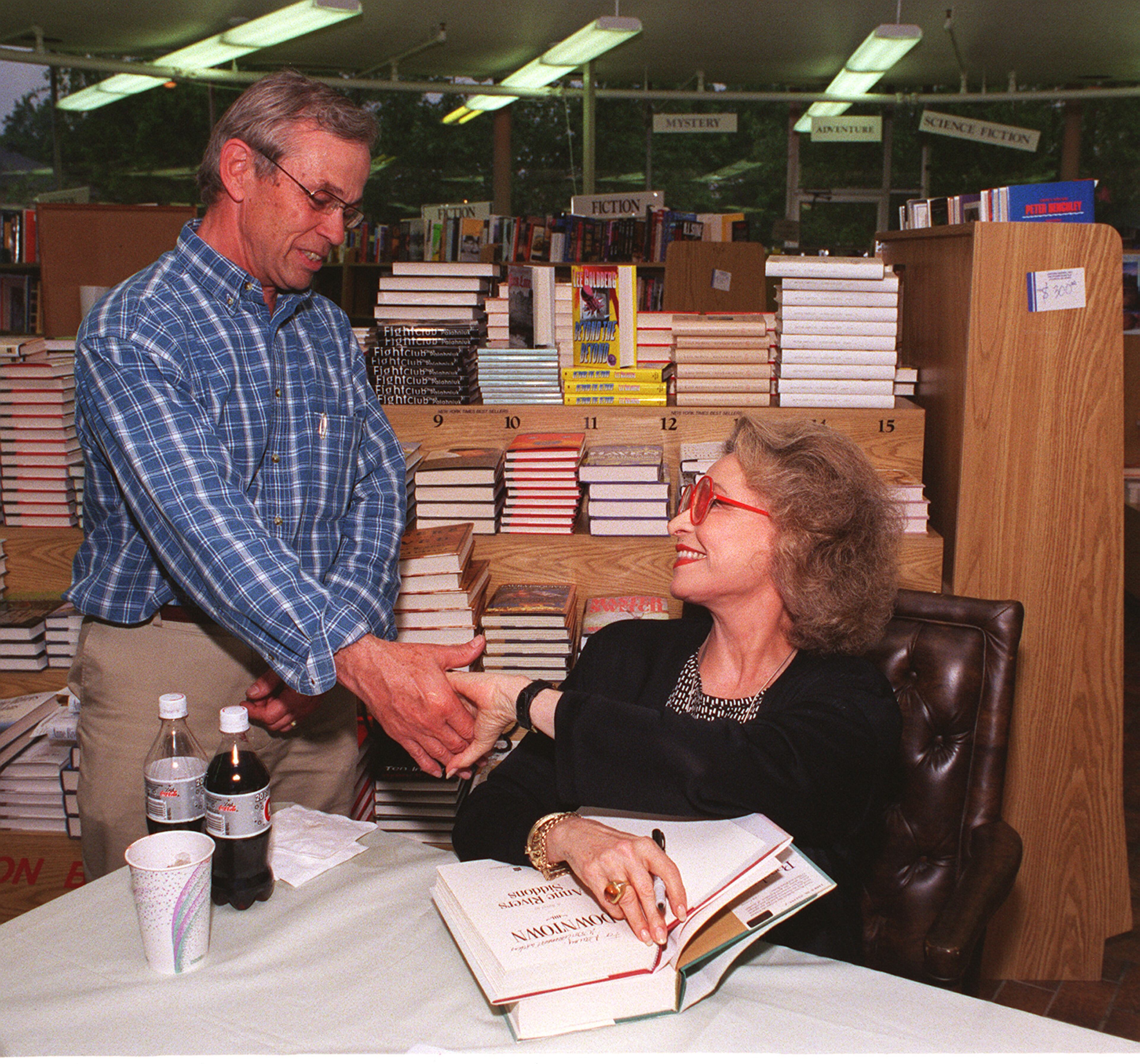 970529: ATLANTA, Ga: Oxford Books owner Rupert LeCraw greets author Anne Rivers Siddons as she participated in the final book signing at the Pharr Road store on Thursday, May 29, 1997. Siddons expressed her dismay that the store was closing. (LAURA NOEL/SPECIAL)