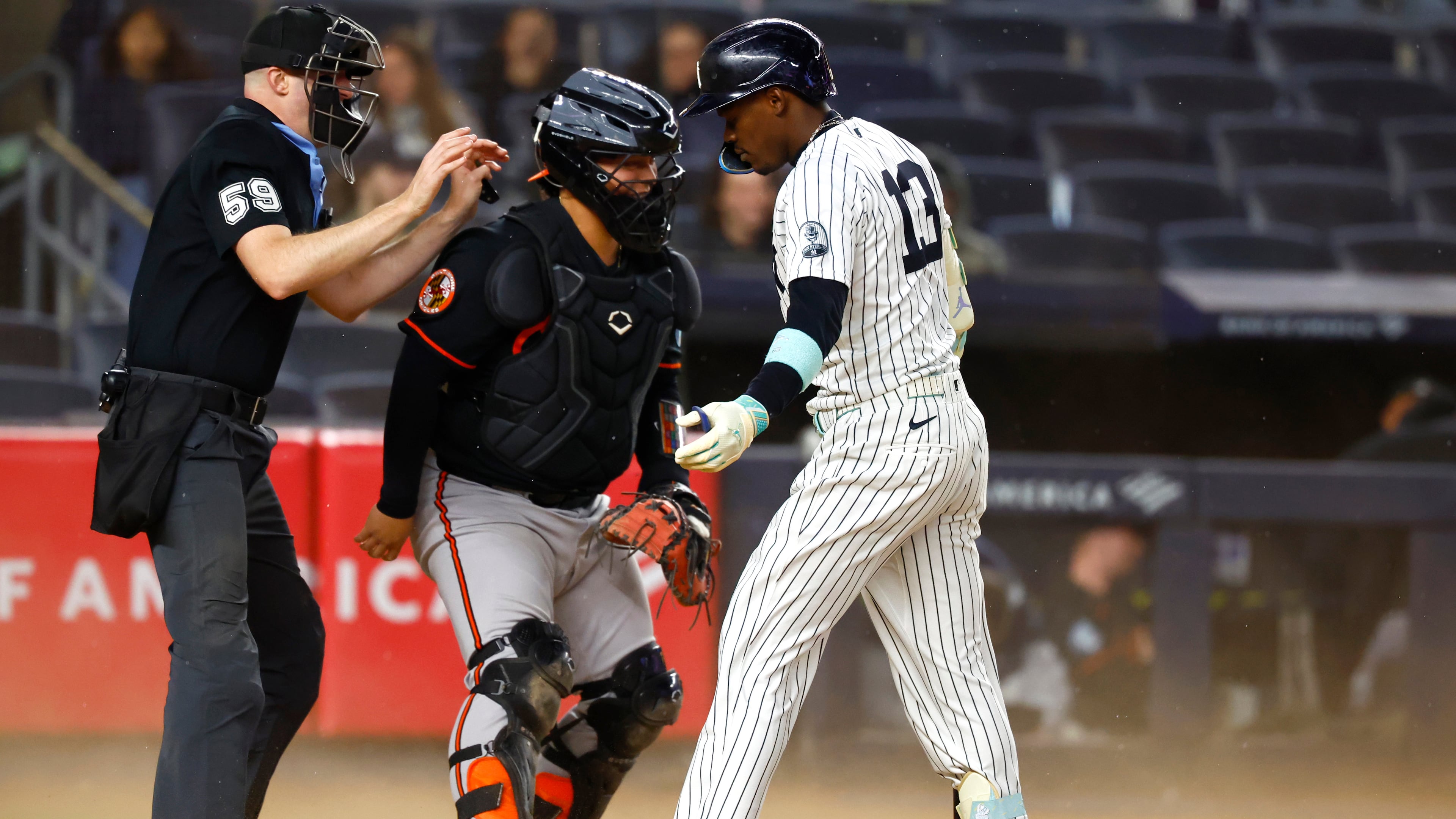 Home plate umpire Nic Lentz, left, calls time after the wind blew up dust during an at-bat of New York Yankees' Jazz Chisholm Jr., right, during the seventh inning of the second baseball game of a doubleheader against the Baltimore Orioles, Friday, Sept. 25, 2026, in New York. (AP Photo/Noah K. Murray)