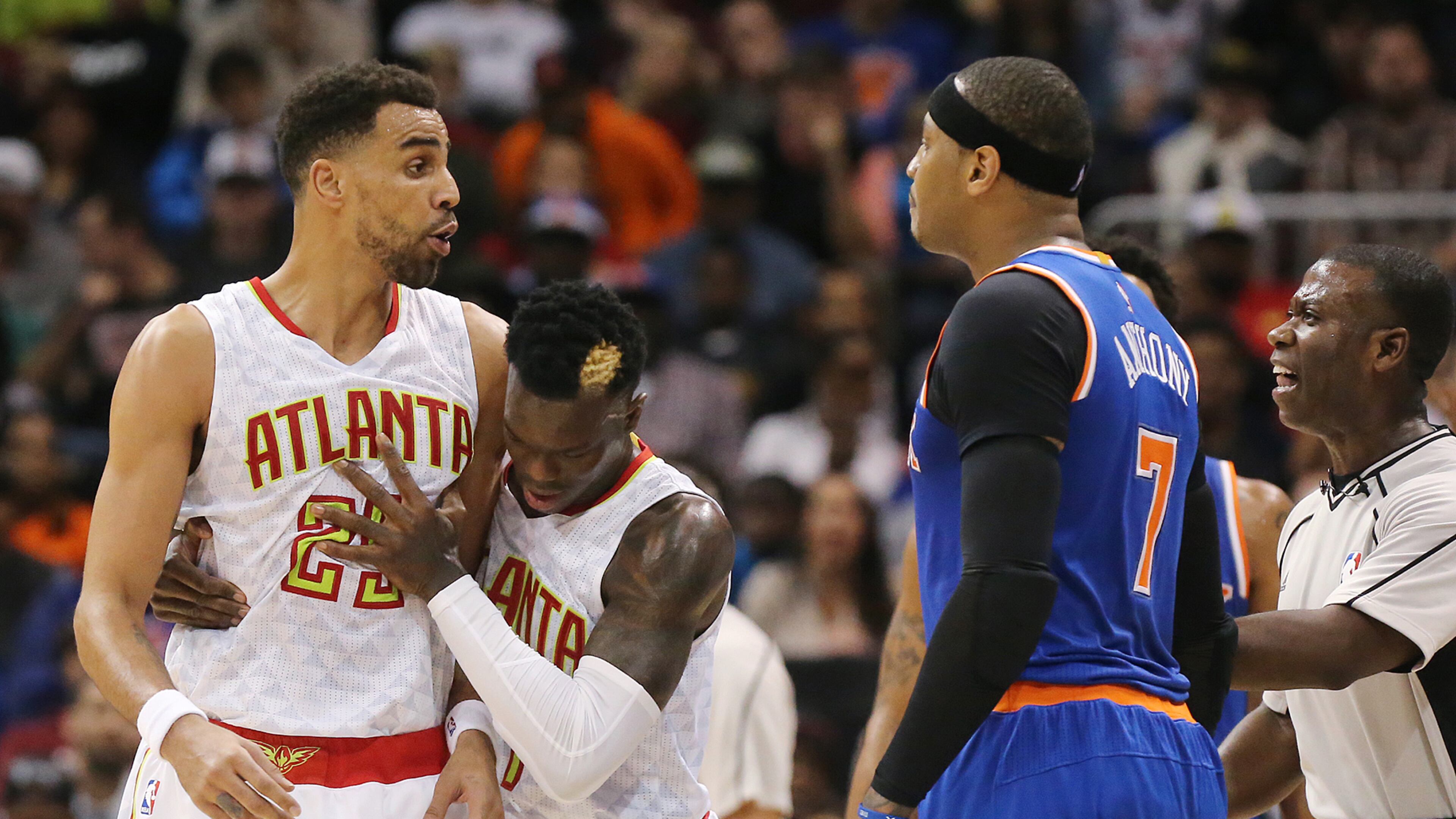 Hawks guard Dennis Schroder and an official separate Thabo Sefolosha and Knicks forward Carmelo Anthony after they were called for a double technical against each other in a NBA basketball game on Wednesday, Dec. 28, 2016, in Atlanta. After a review of the play Anthony was given a flagrant foul 2 and ejected from the game. Curtis Compton/ccompton@ajc.com