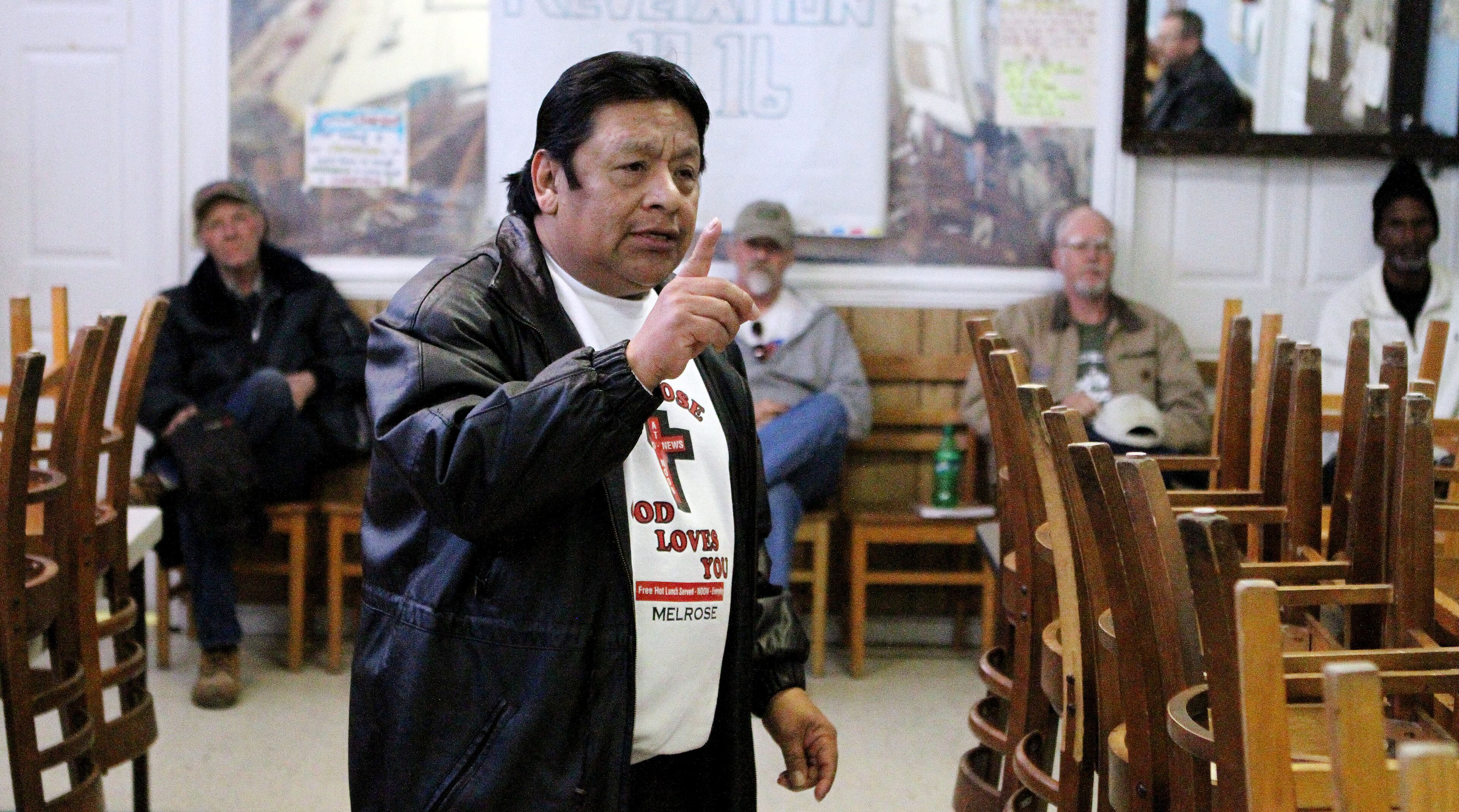Ramirez leads a house meeting of residents at the Good News at Noon homeless ministry. Those who stay overnight are expected to help out in exchange for a place to stay.